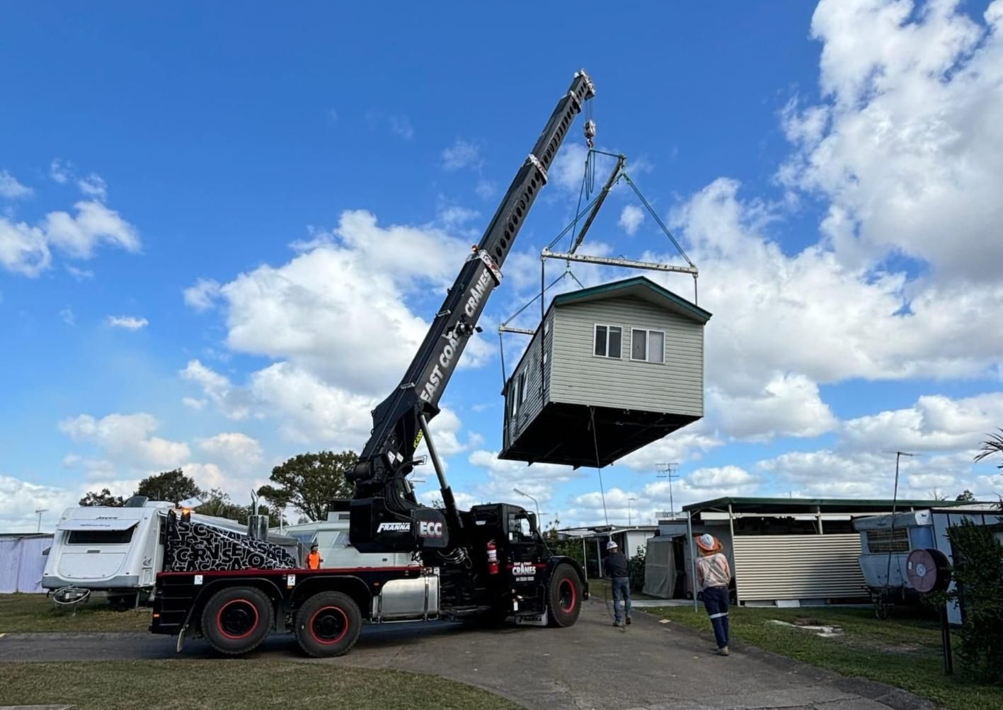 A Crane Lifts a Small Cabin — East Coast Cranes in Ormeau, QLD