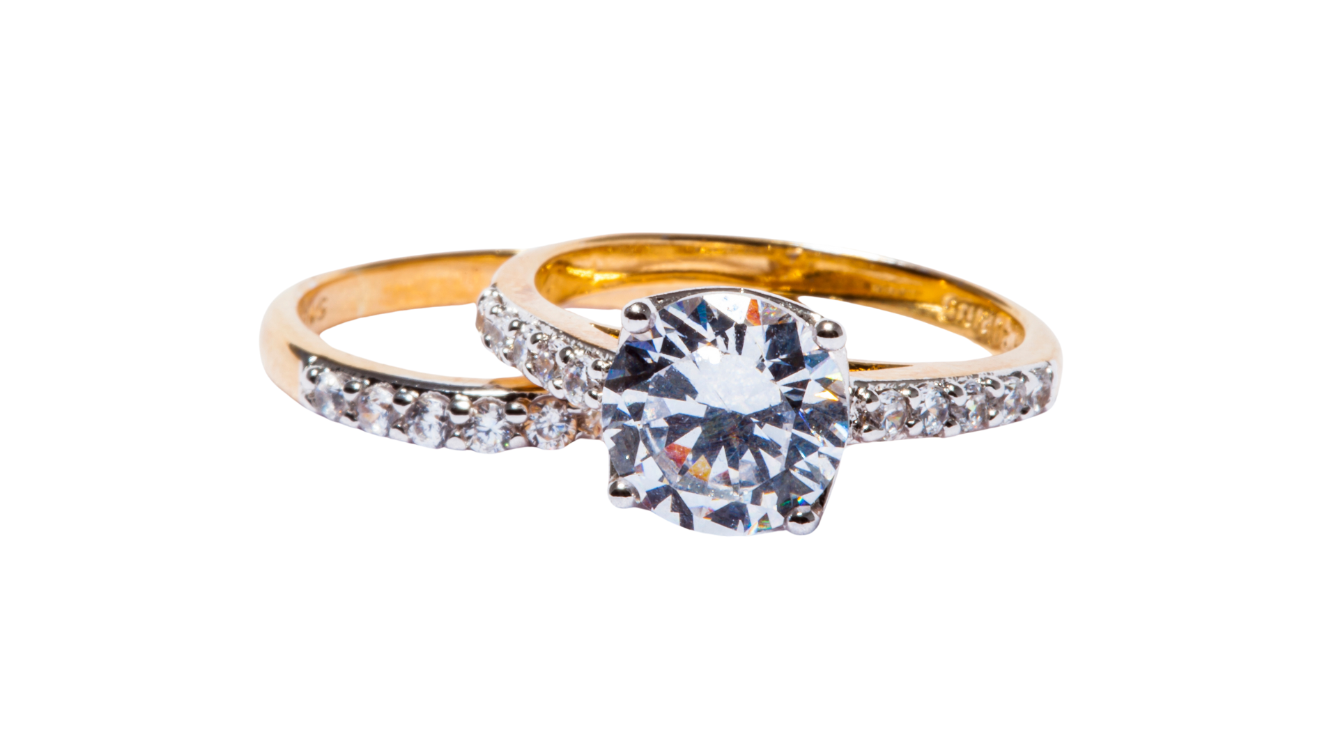 A couple of gold rings with diamonds on a white background.