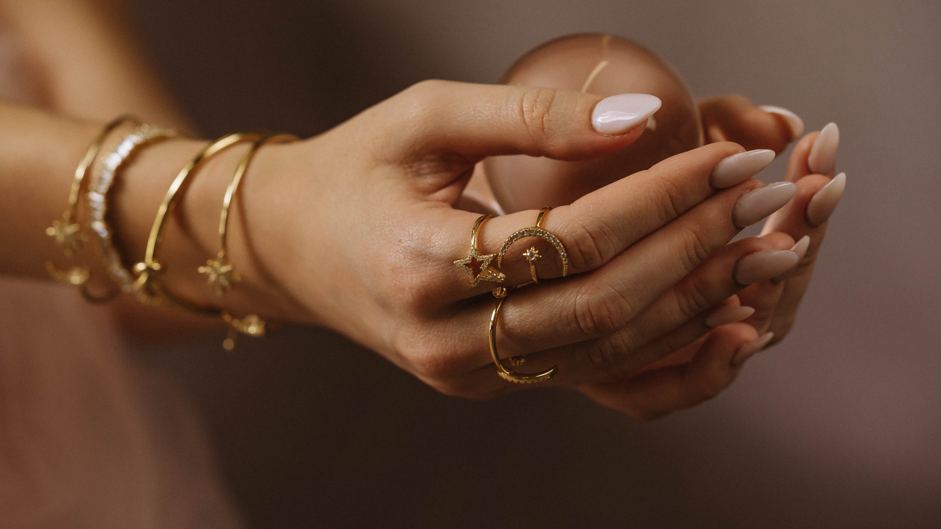 A woman is holding a glass ball in her hands.