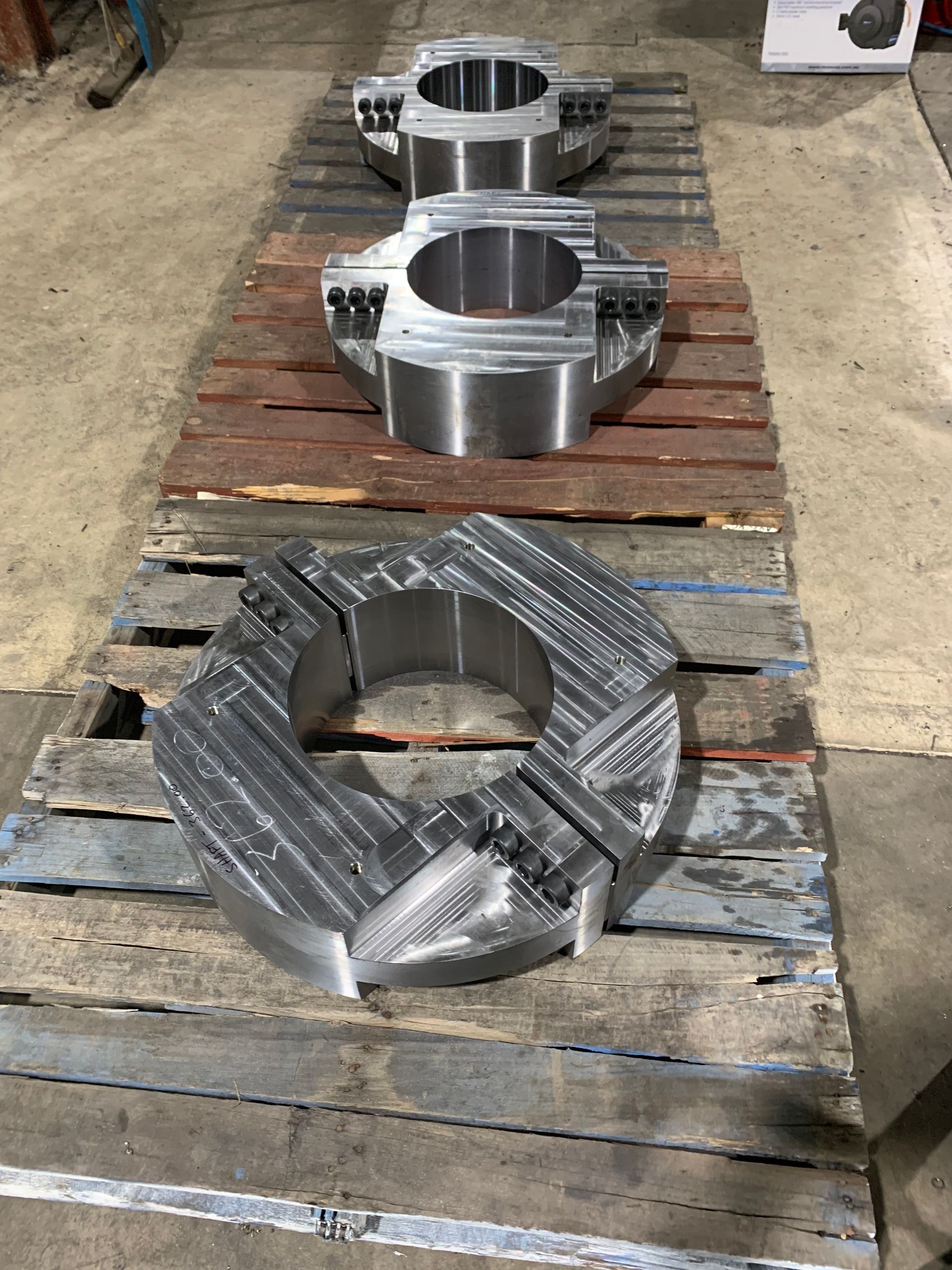 A machine is cutting a piece of metal in a factory.