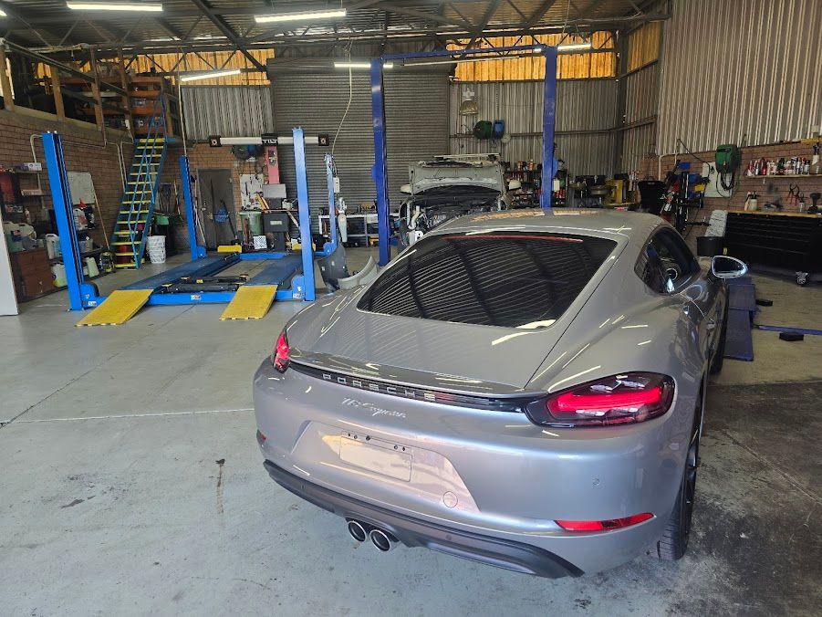 A Gray Sports Car Is Parked In A Garage — Nuron Inspection & Service Centre In Broadmeadow, NSW