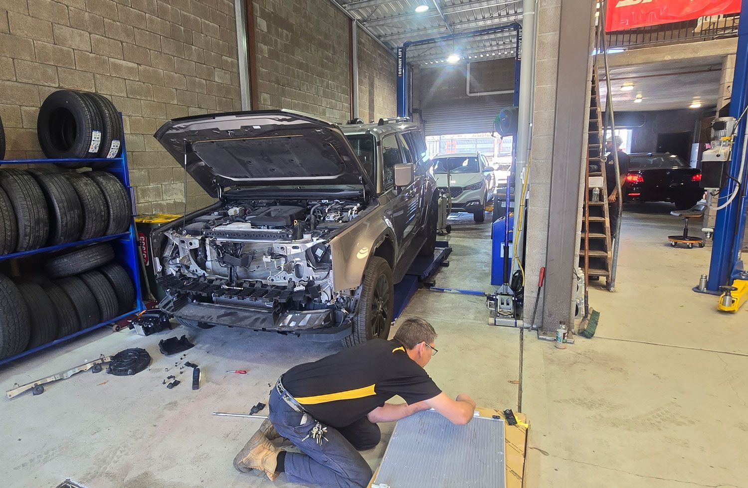 Mechanic In Newcastle Working On A Grey Car