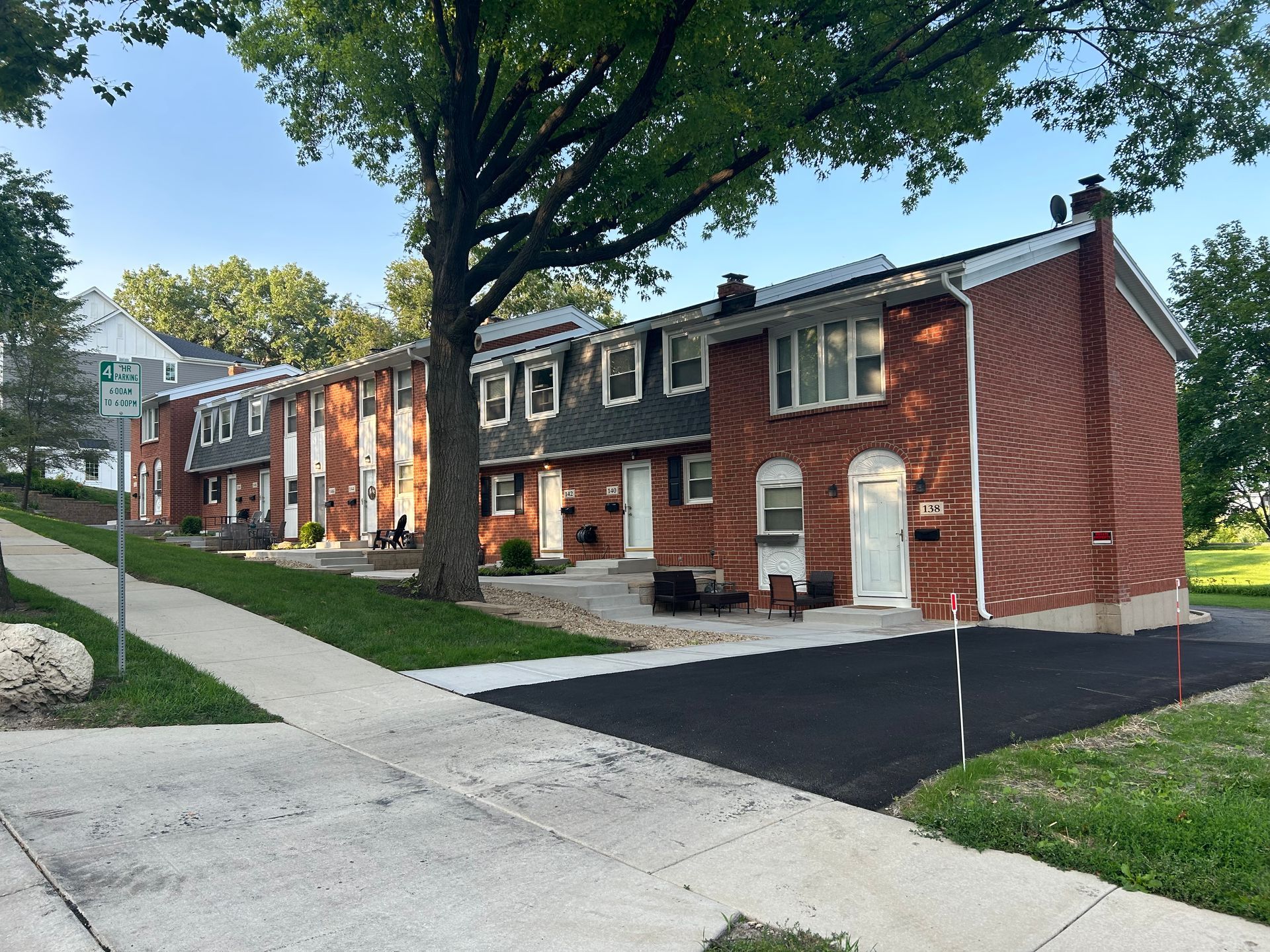 a row of brick houses with a sidewalk in front of them