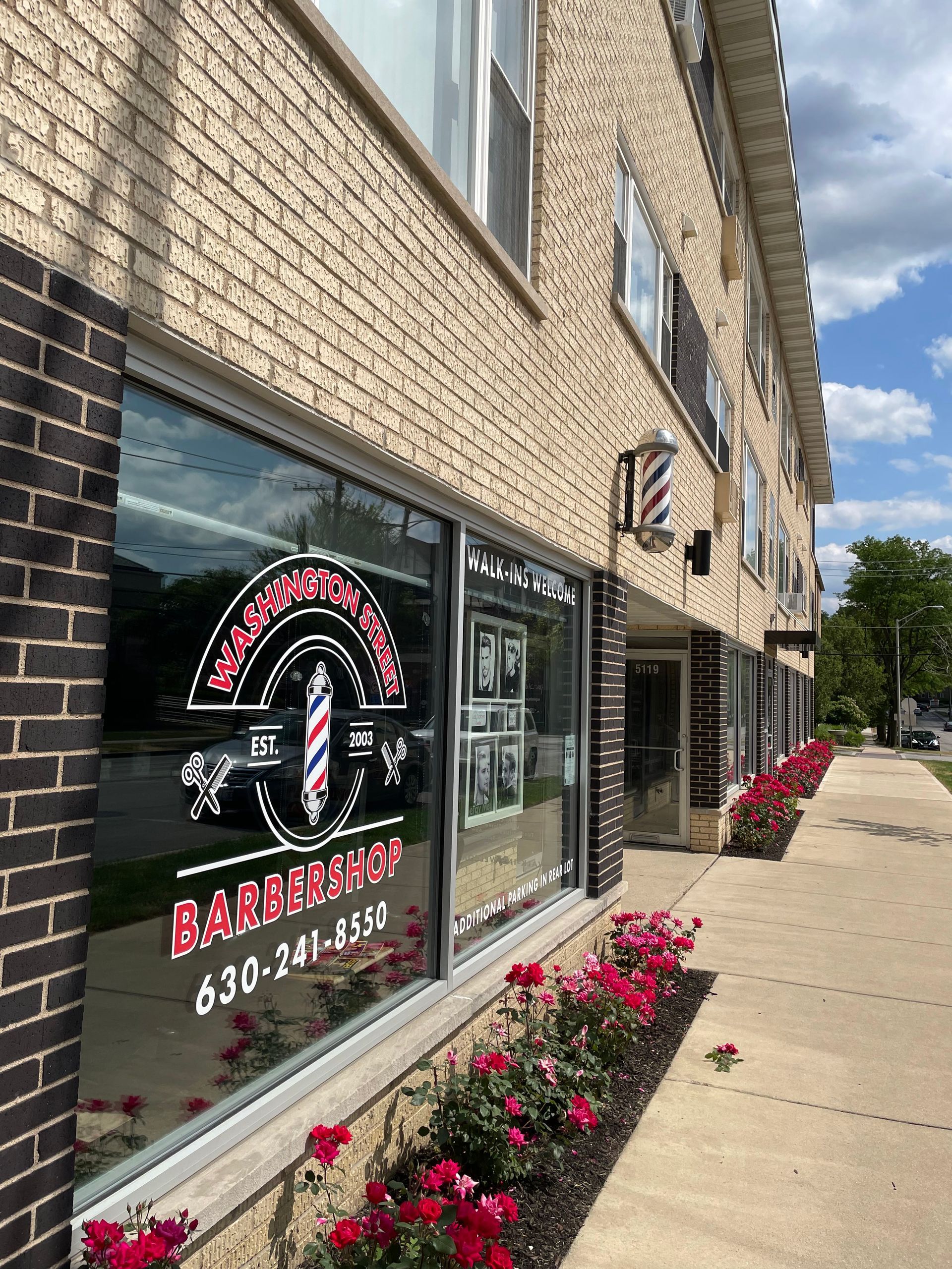 a brick building with a barber shop in the window .