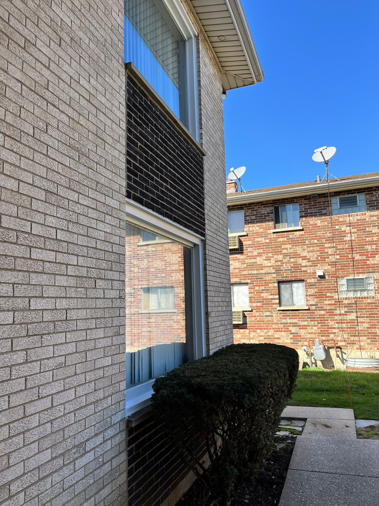 a brick building with satellite dishes on top of it
