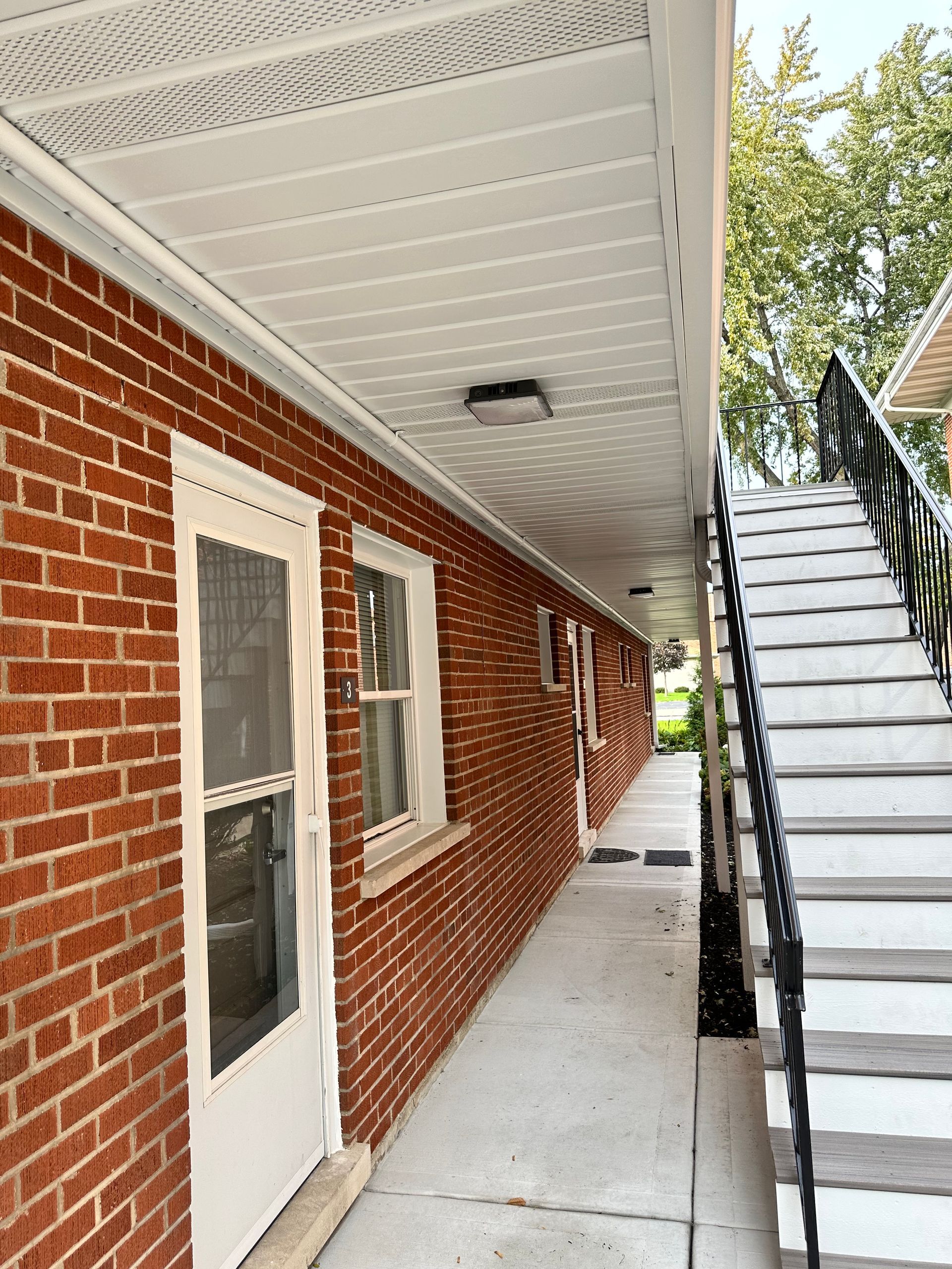 a brick building with stairs leading up to it .