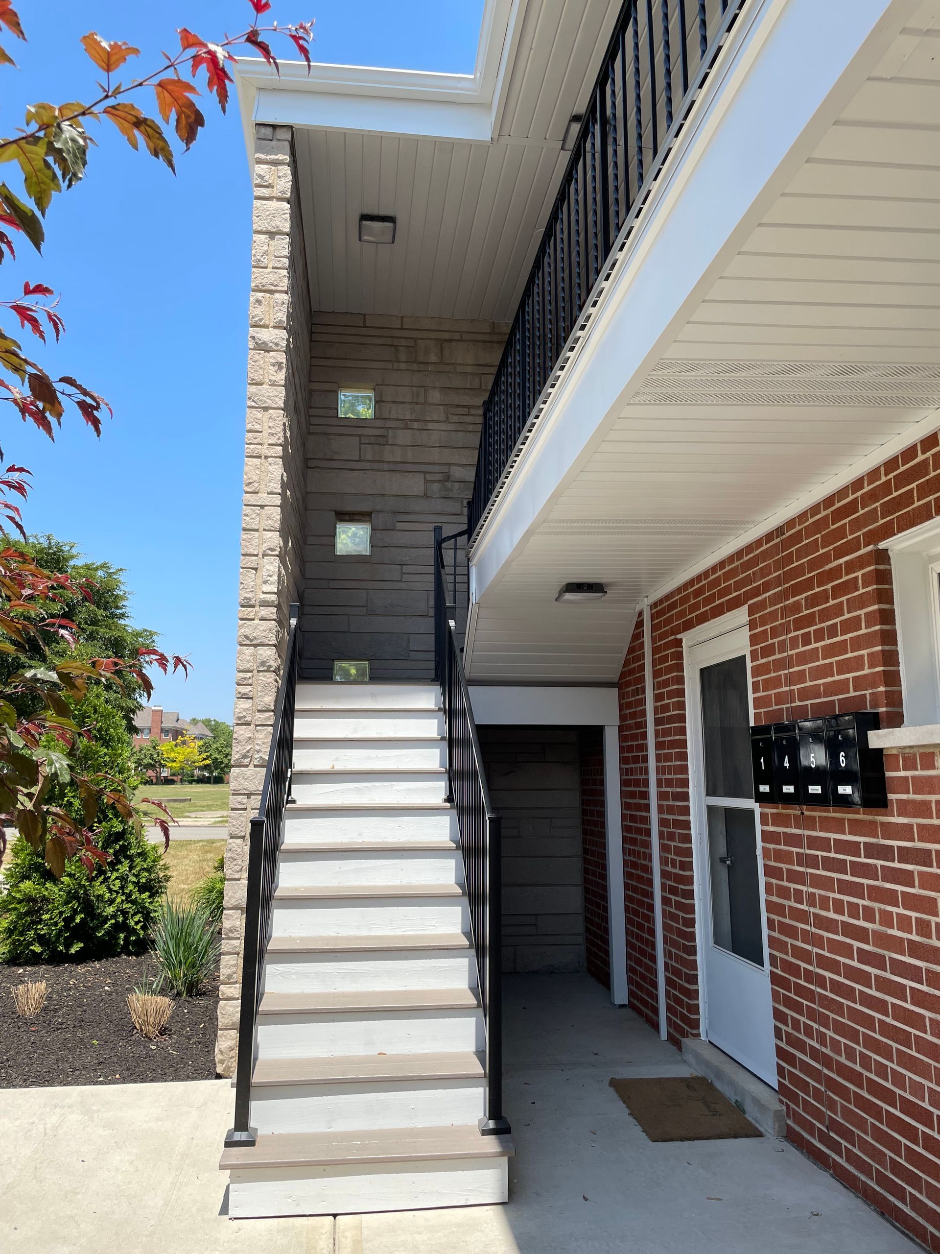 a brick building with stairs leading up to the second floor
