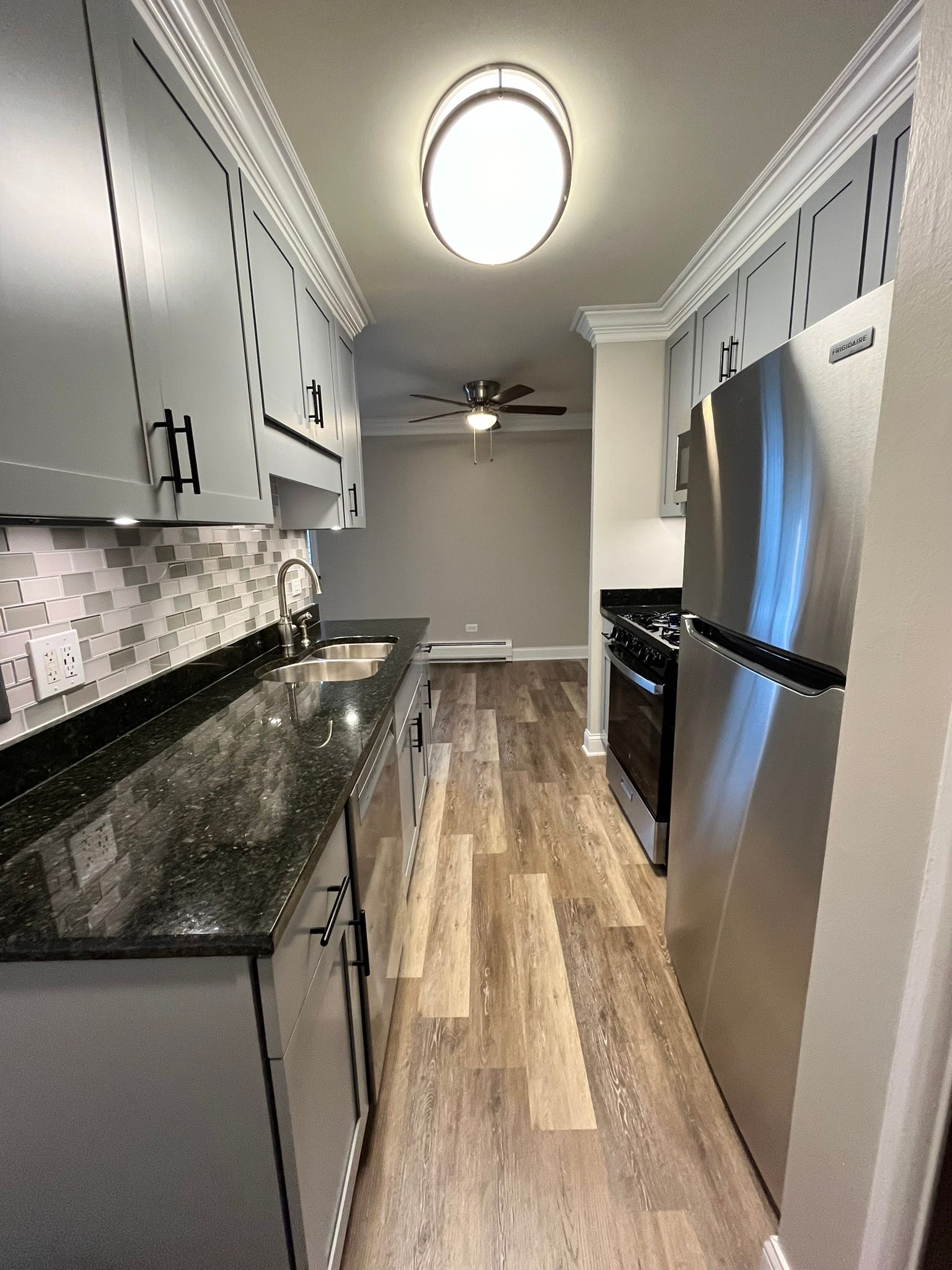 A kitchen with stainless steel appliances and granite counter tops.