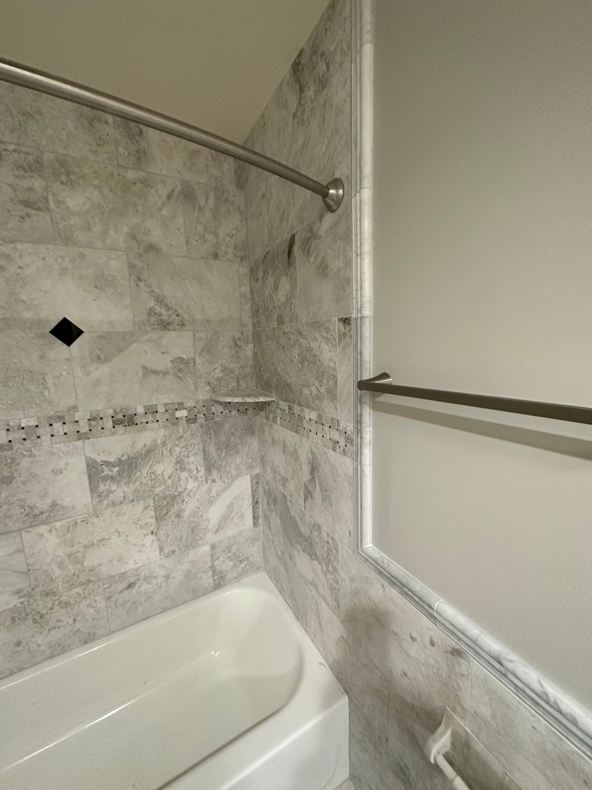 a bathroom with a bathtub and a shower .