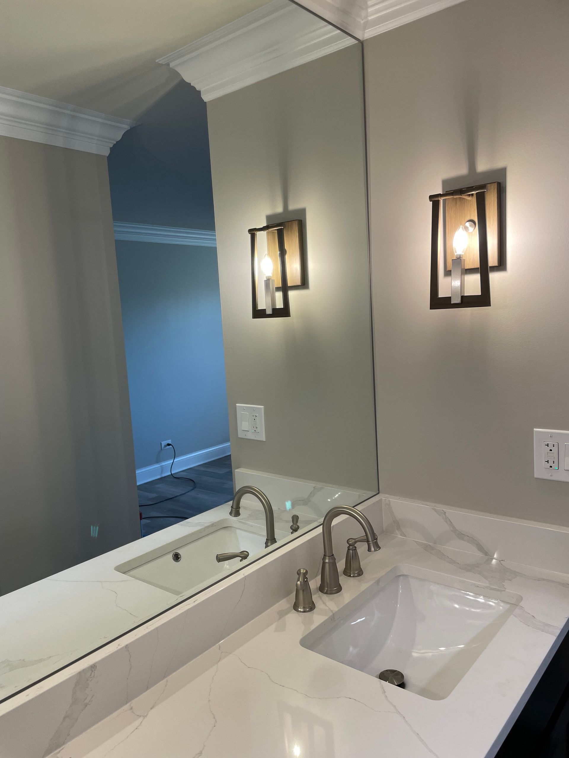 a bathroom with a sink and a large mirror .