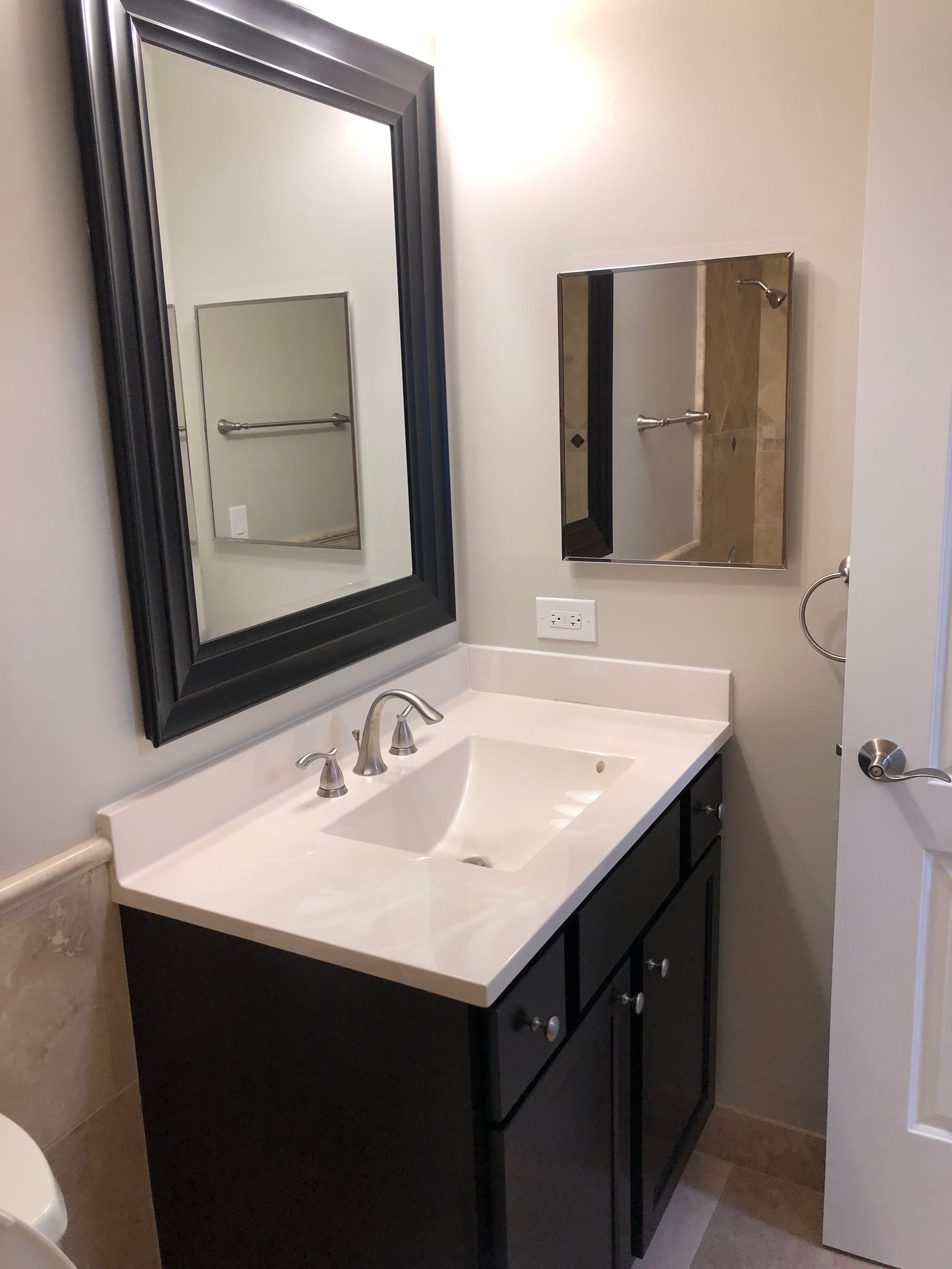 a bathroom with a sink a mirror and a toilet