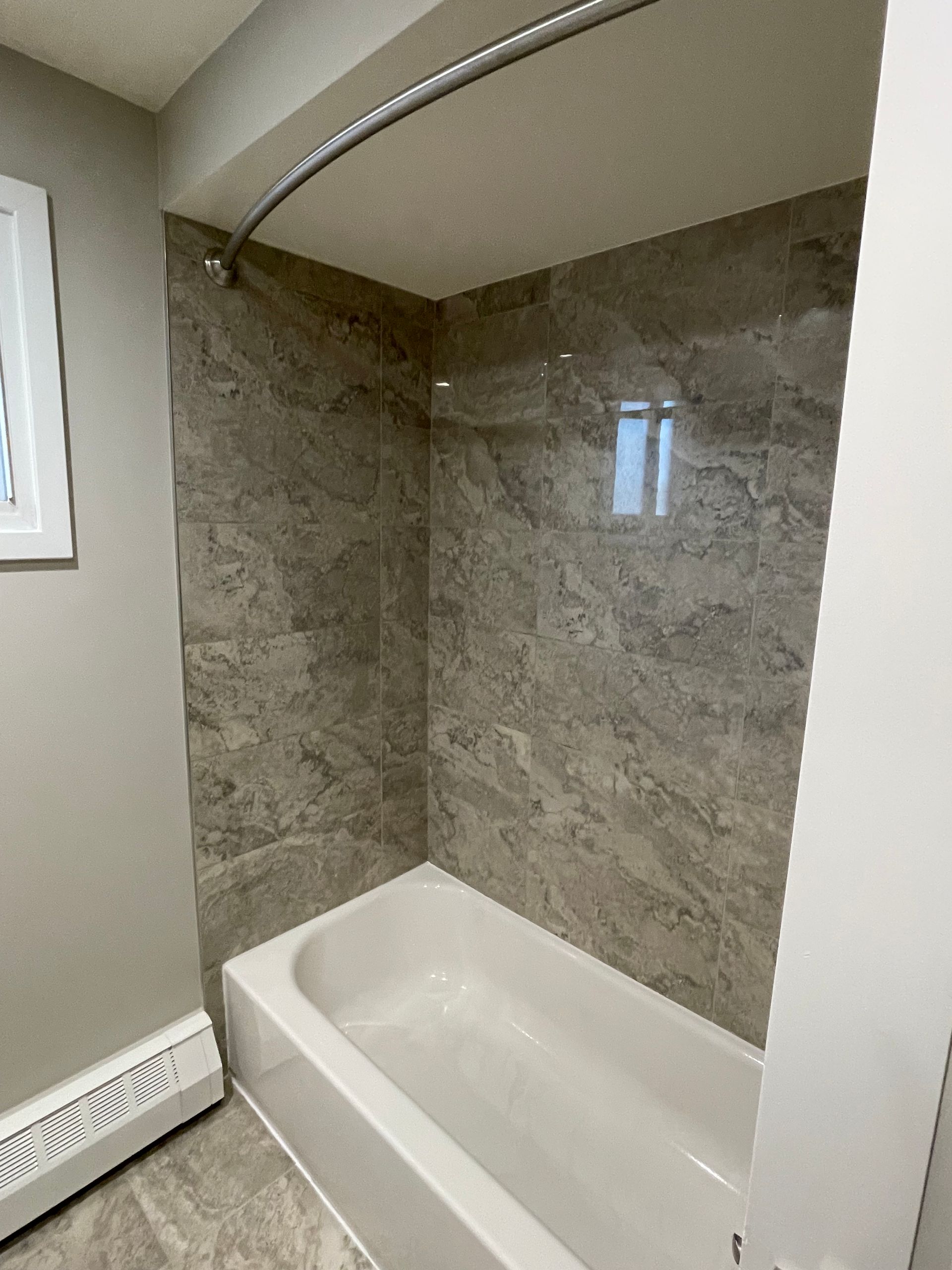 a bathroom with a bathtub and a shower curtain .