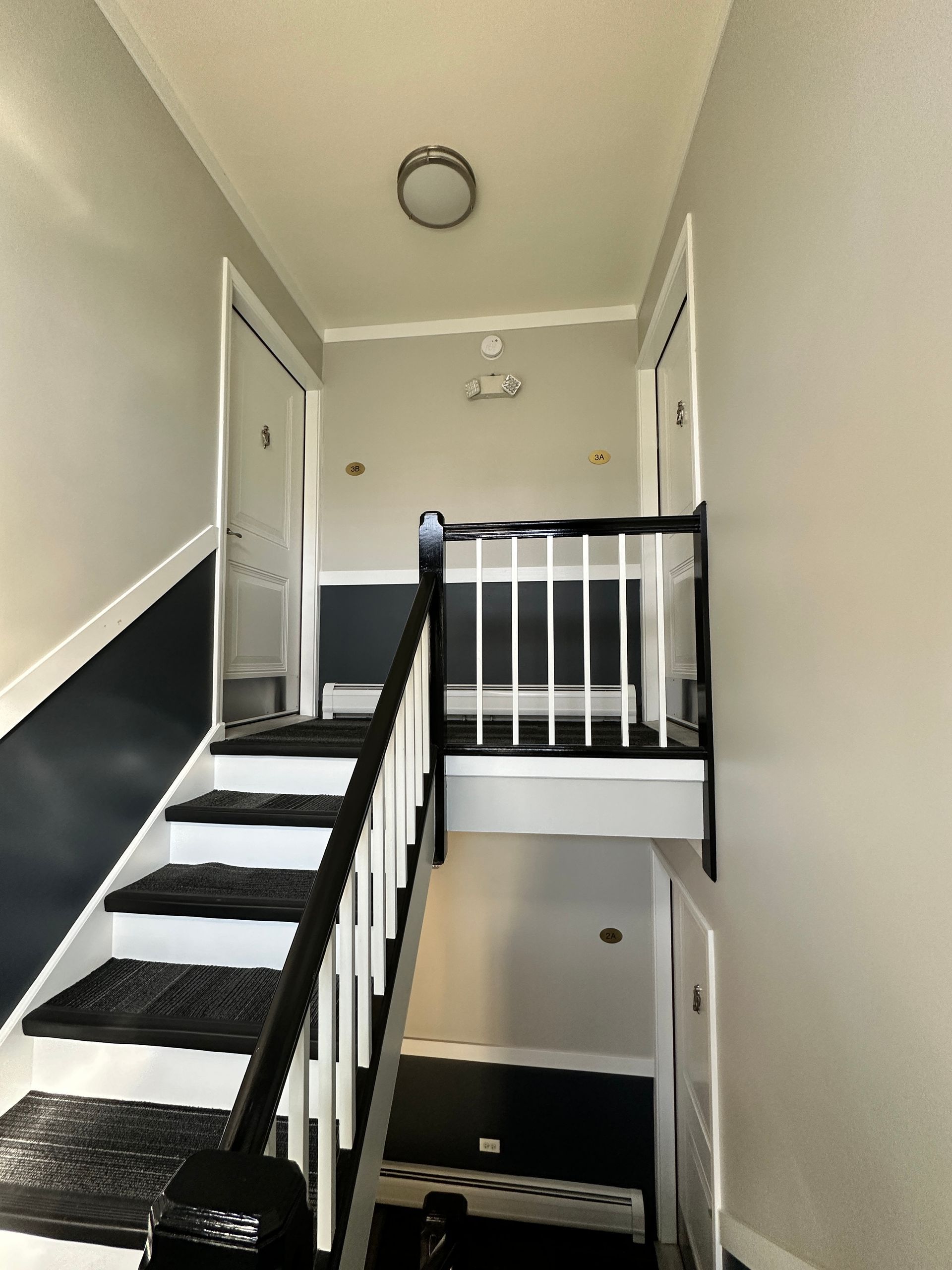 a hallway with stairs leading up to the second floor