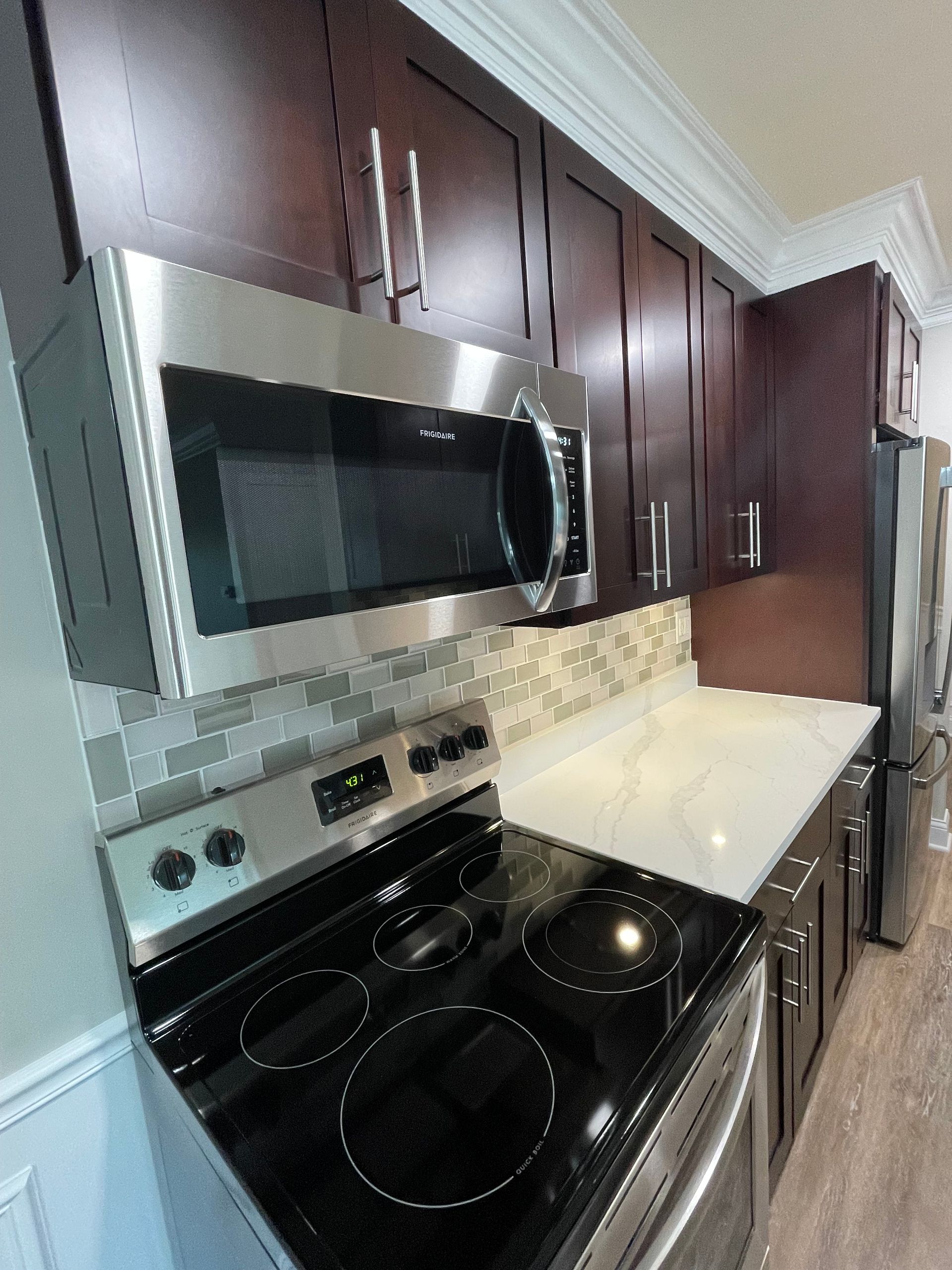 a kitchen with stainless steel appliances including a stove and microwave