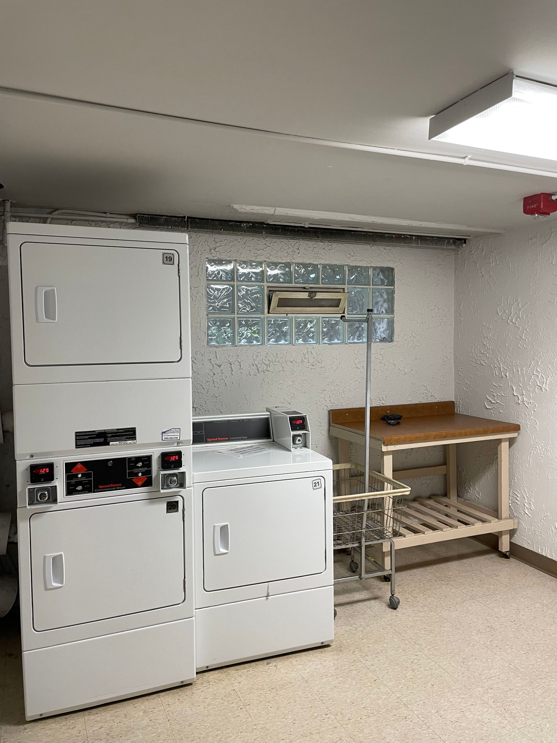 a laundry room with a washer and dryer stacked on top of each other .