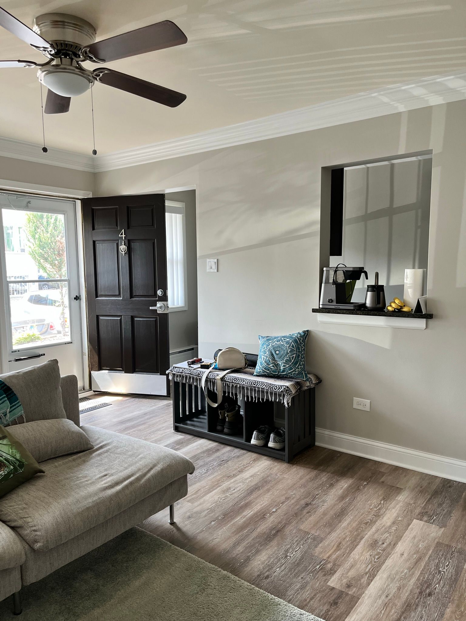 a living room with a couch and a ceiling fan .