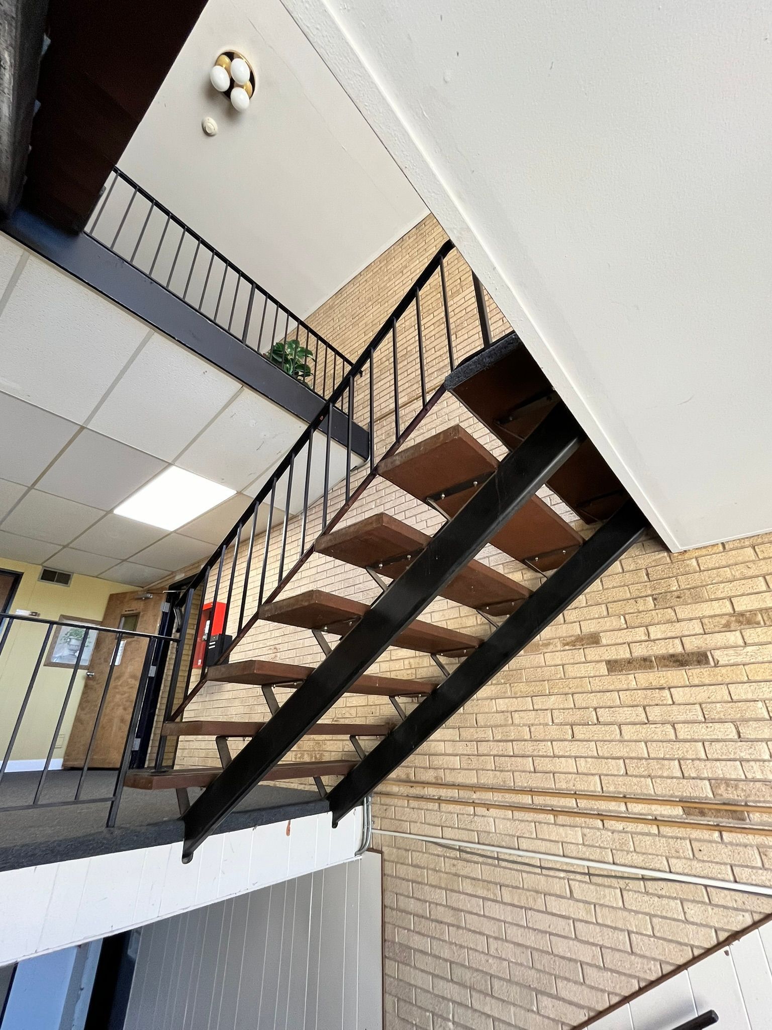 a staircase in a building with a brick wall