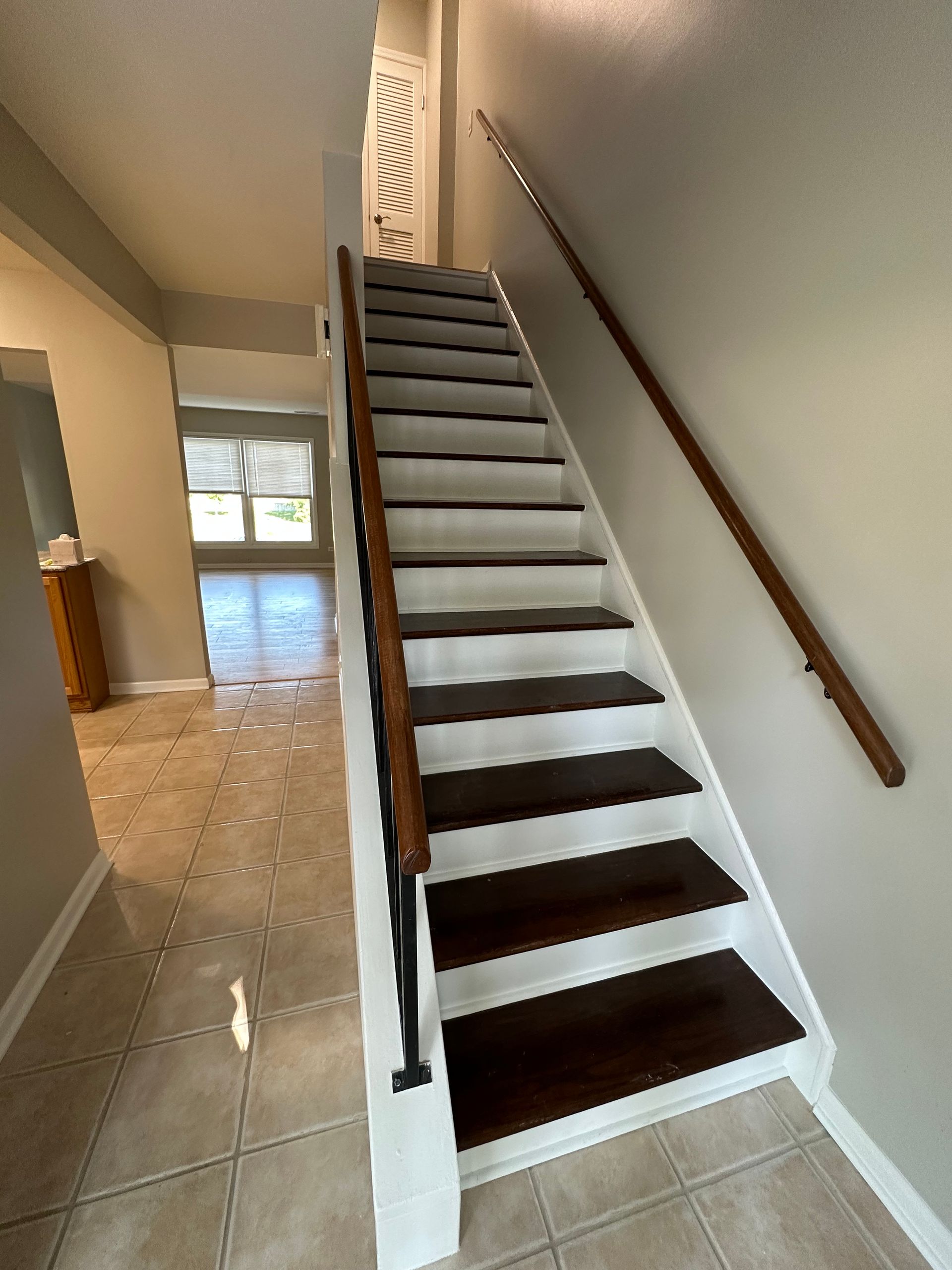 a set of stairs leading up to the second floor of a house .