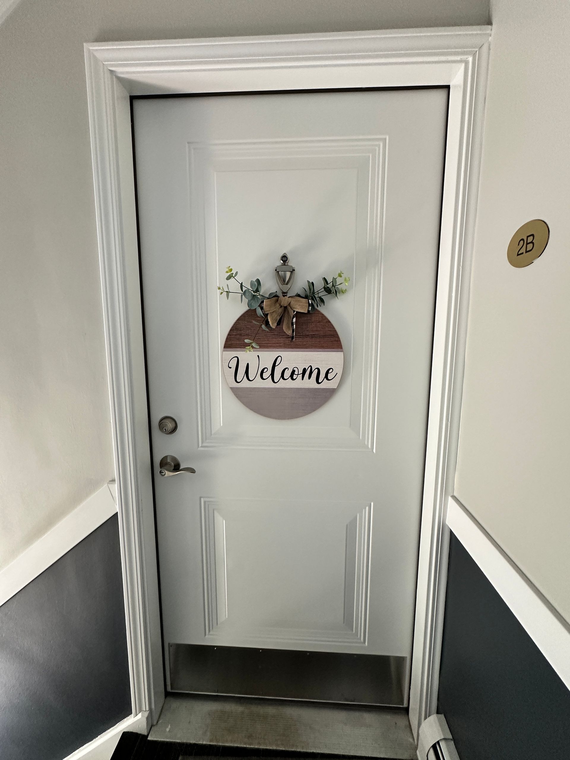 a white door with a welcome sign on it