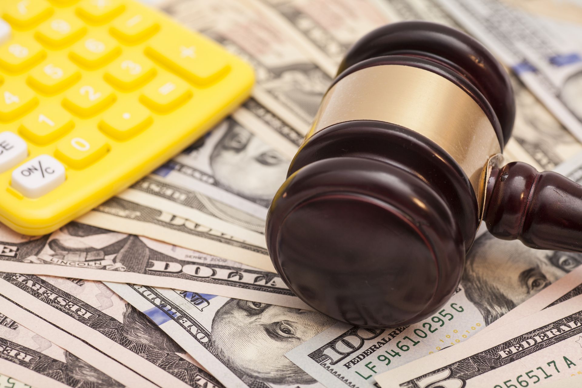 Gavel on the top of dollars