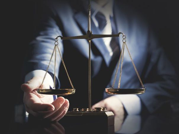 An attorney touching a liberty scale