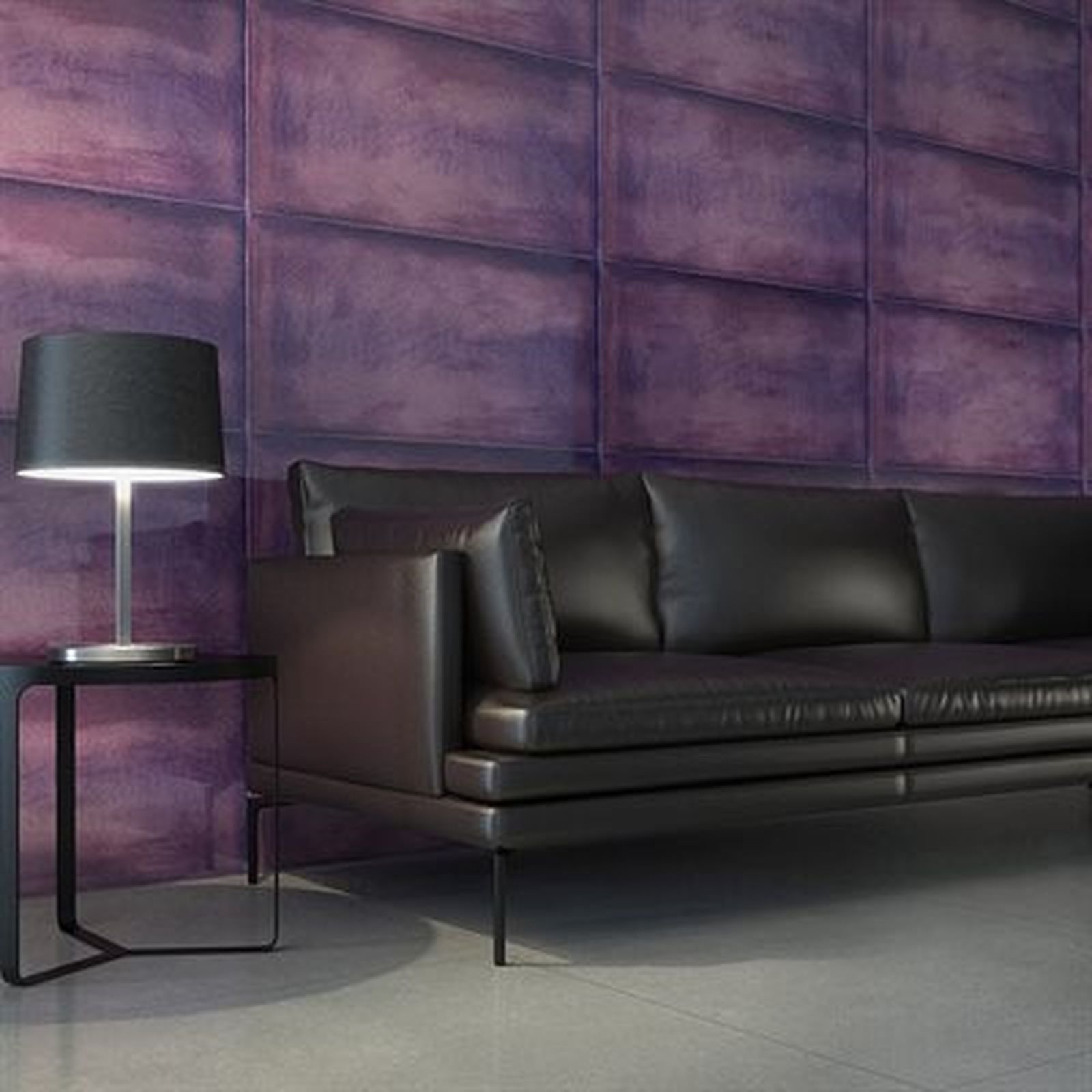 Black leather sofa and side table with lamp against a purple textured wall.