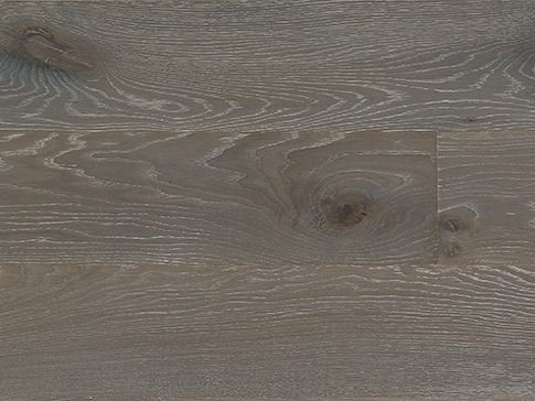 Close-up of hardwood flooring planks in shades of gray with prominent wood grain texture and knots.