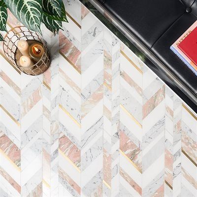 Herringbone marble floor with pink and gold accents, next to a black leather ottoman.