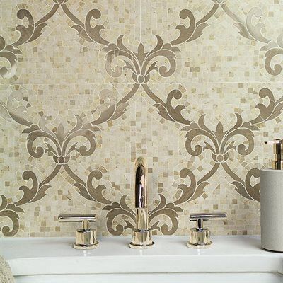 Bathroom with ornate mosaic tile wall and gold faucet.