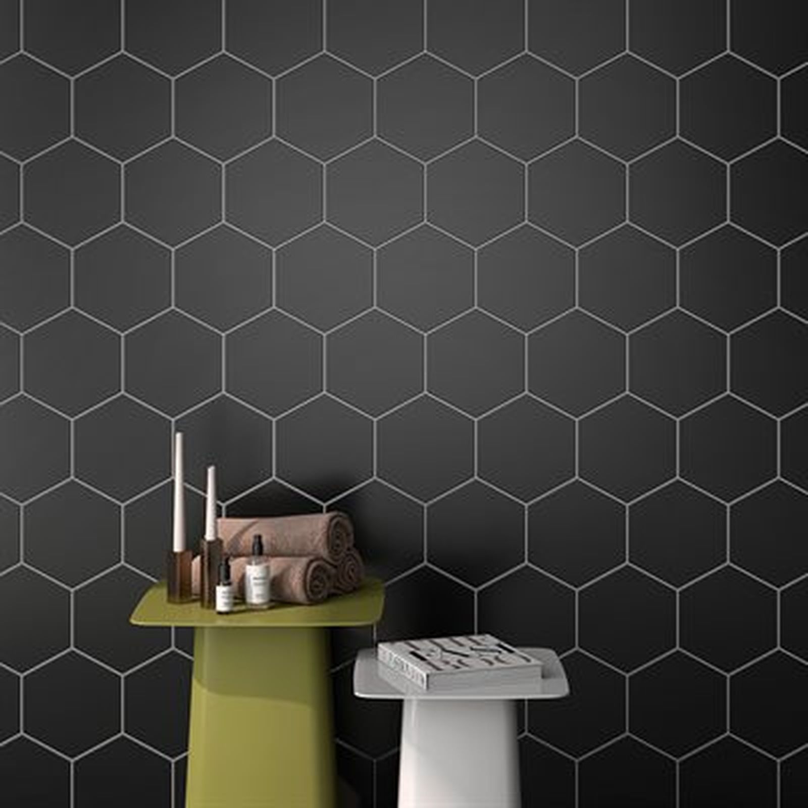 Black hexagon tile bathroom with green and white side tables, towels, and toiletries.