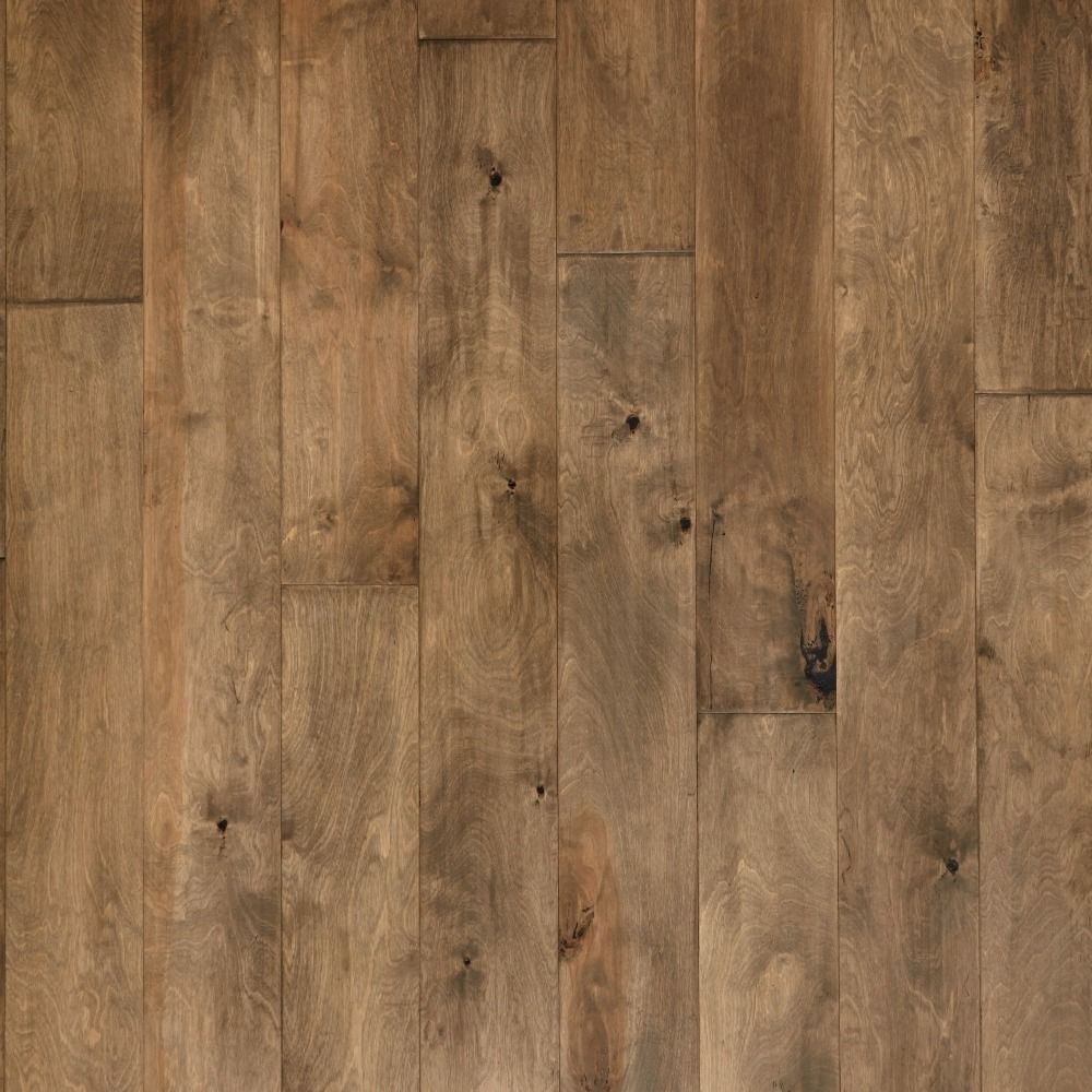 Close-up view of wooden flooring, various shades of brown, knots, vertical planks.