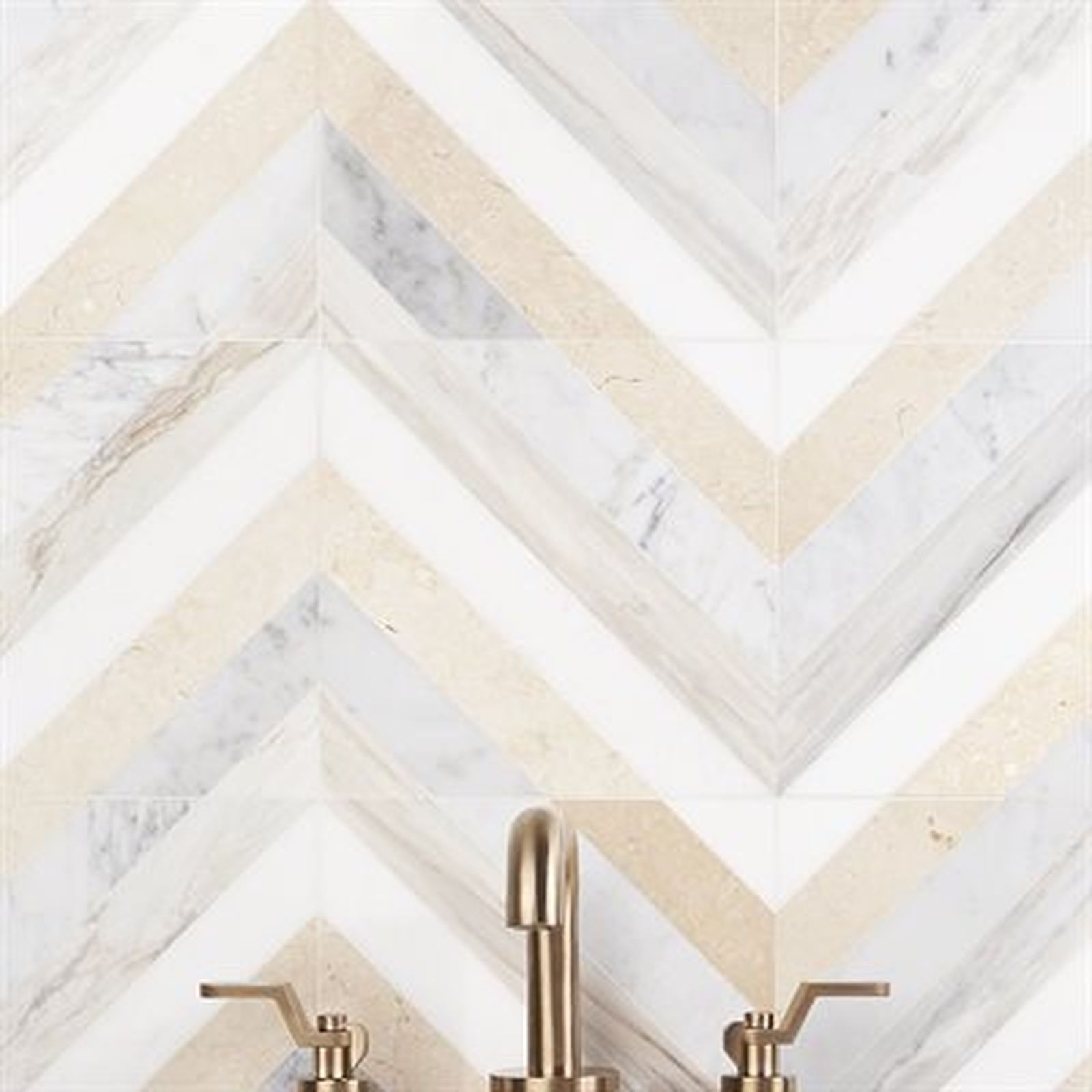 Chevron pattern tile backsplash with gold faucet.