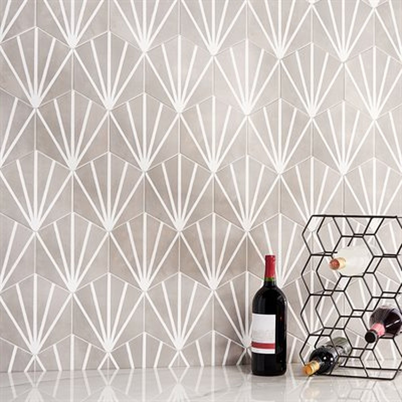 Gray tile wall with white fan pattern, wine bottles, and rack.