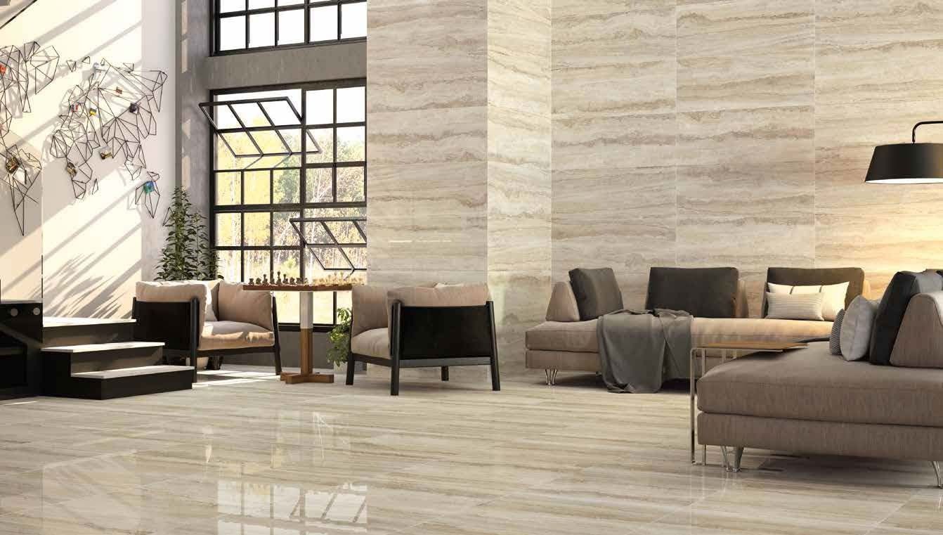 Spacious living room with stone walls, large windows, and a sofa.