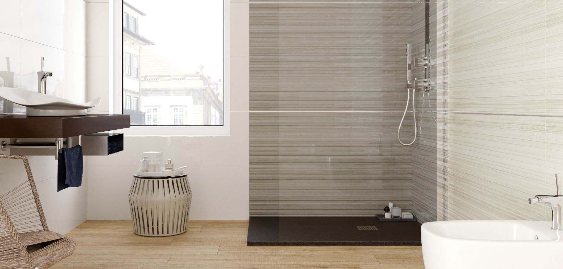 Modern bathroom with a shower, sink, and window. Beige and brown tones.