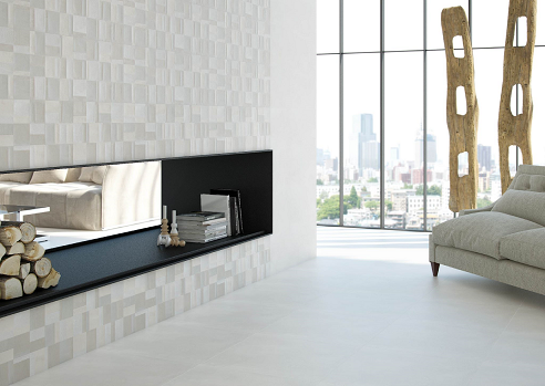 Modern living room with fireplace, white walls and floors, sofa, and city view.
