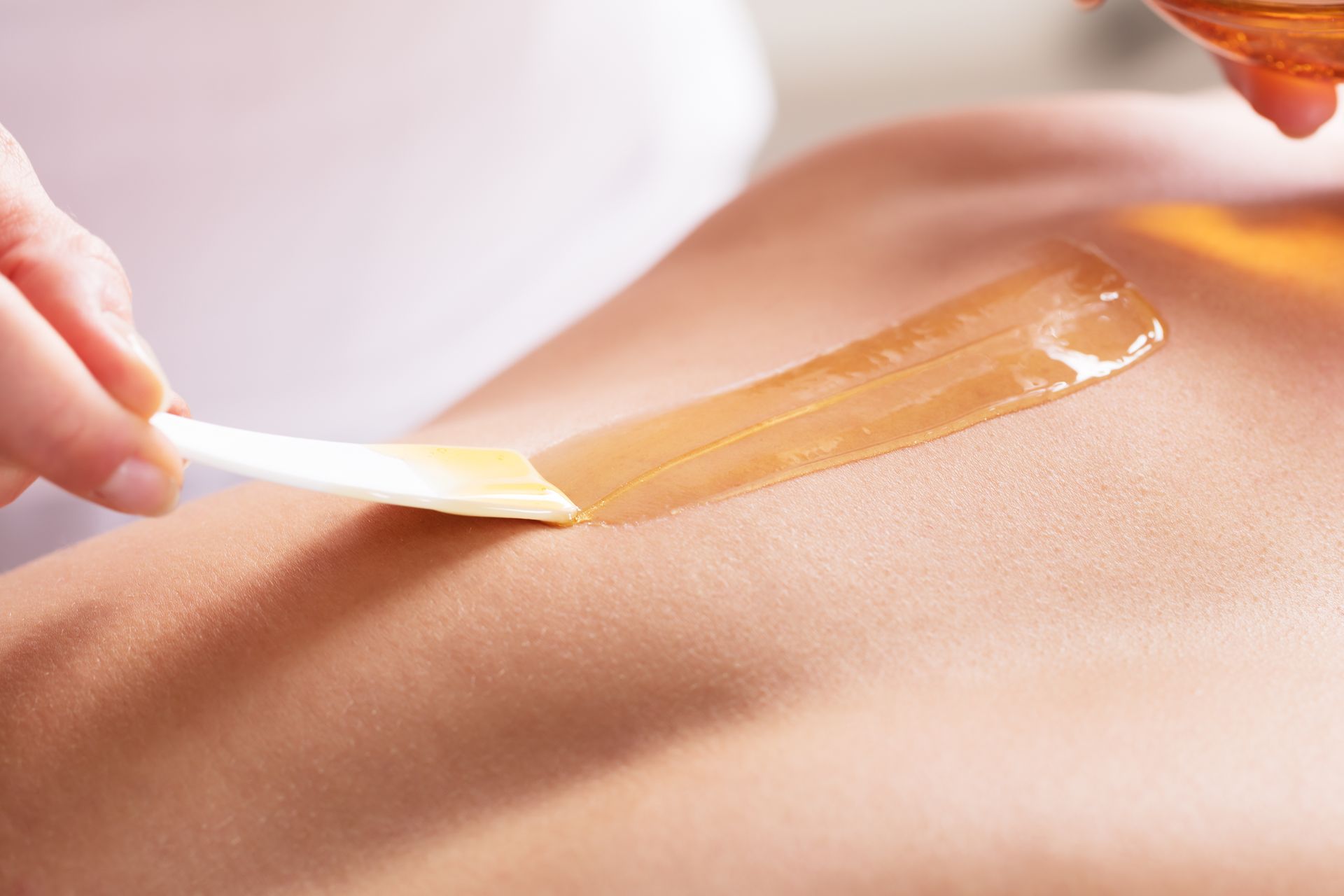 Waxing strip applied to skin during hair removal treatment