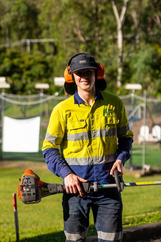 A man holding a whipper snipper.