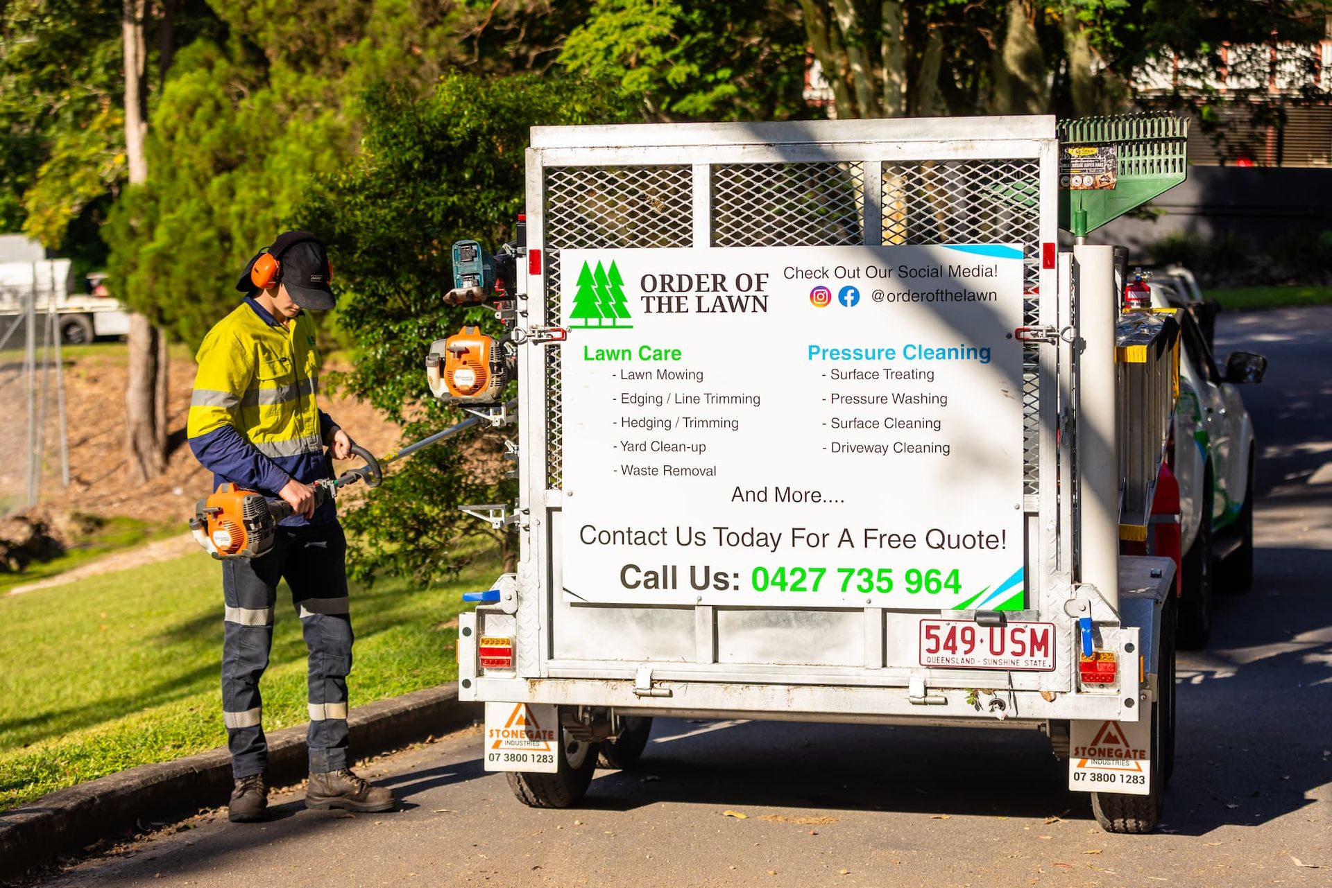 A brick walkway in a garden surrounded by trees and bushes.