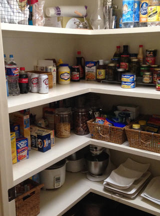 A pantry filled with lots of food and appliances.