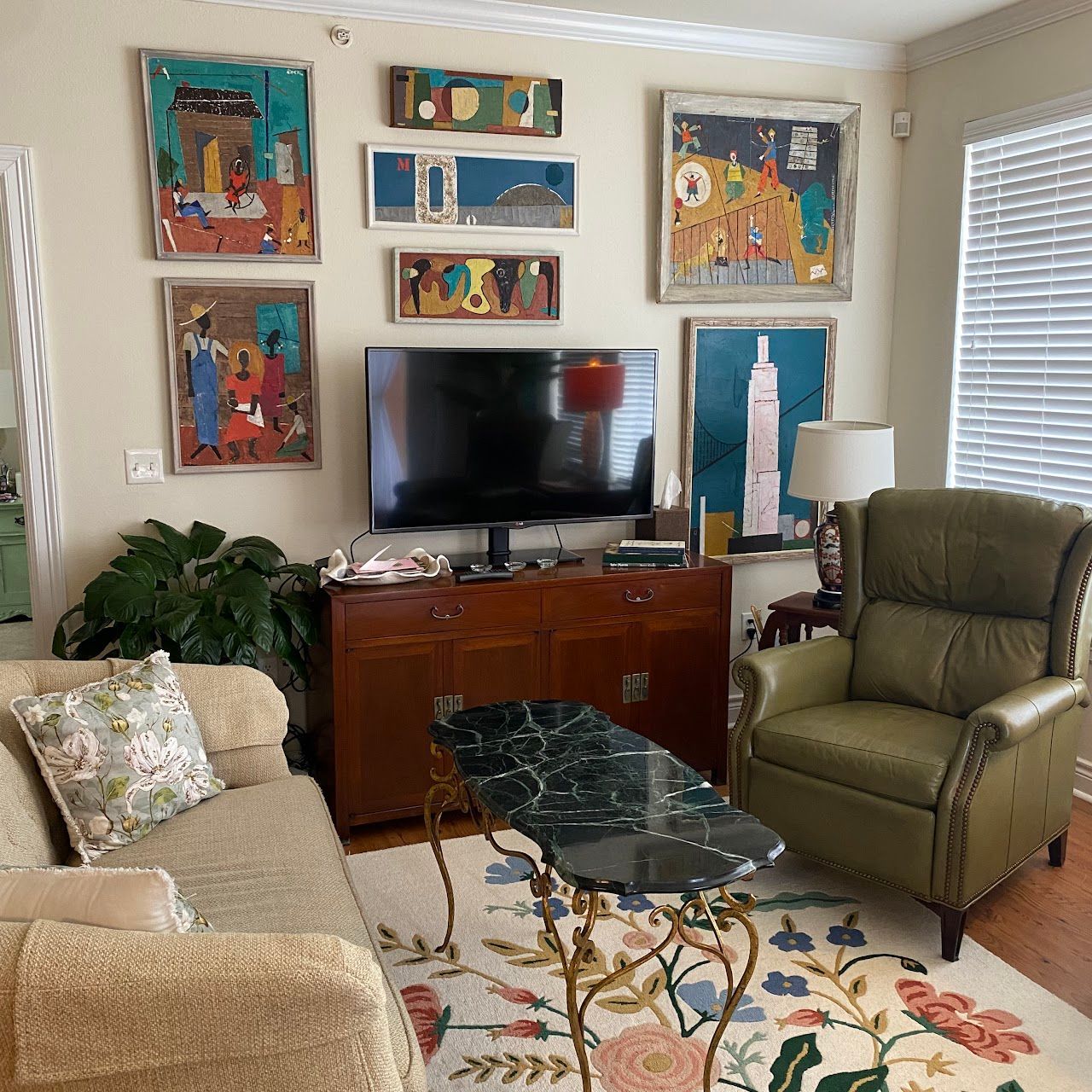 A living room with a couch a chair and a television