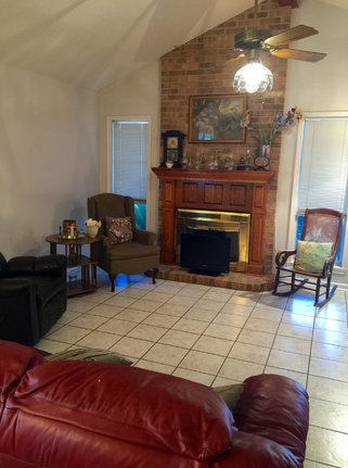 A living room with a fireplace and rocking chairs