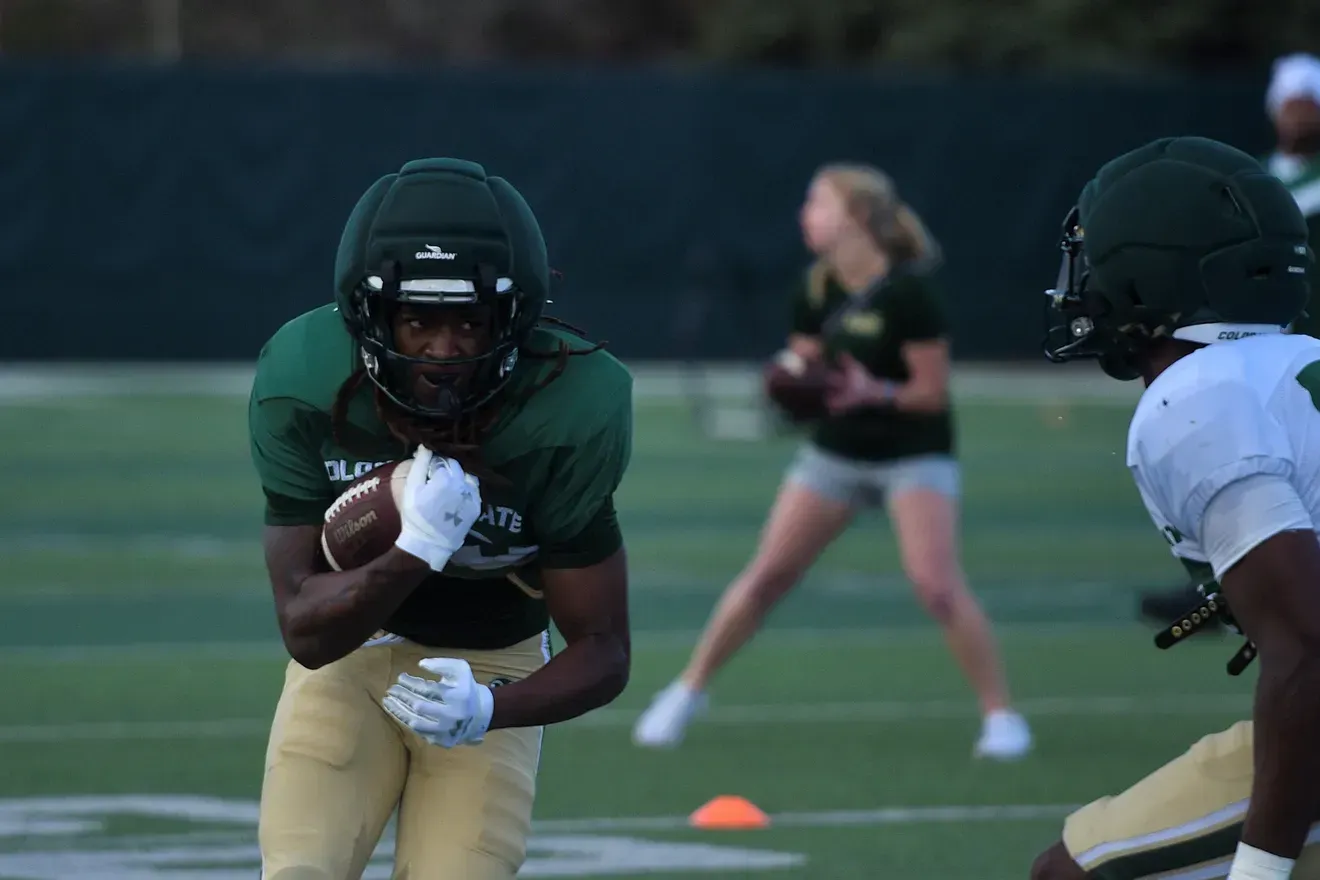 Damian Moore Jr., Running Back, practicing in green and gold uniform