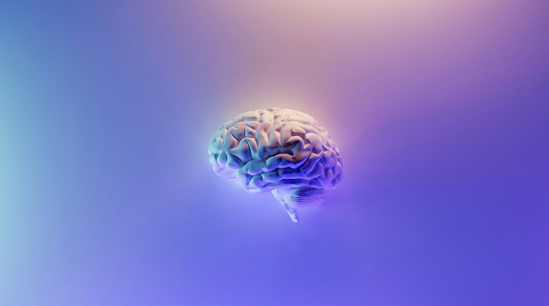Brain illuminated with blue and purple light against a gradient background.