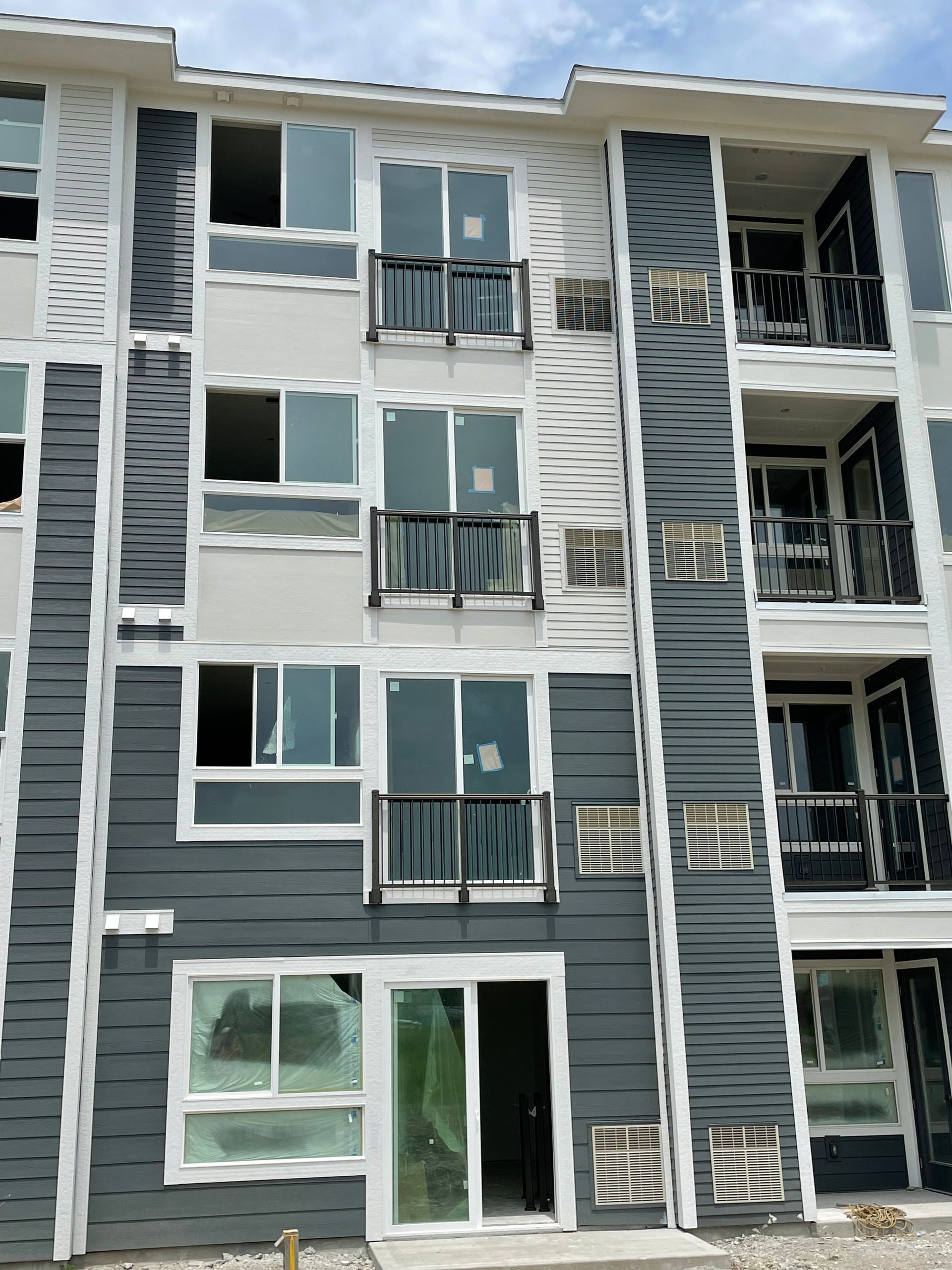 A building with a lot of windows and balconies is under construction.