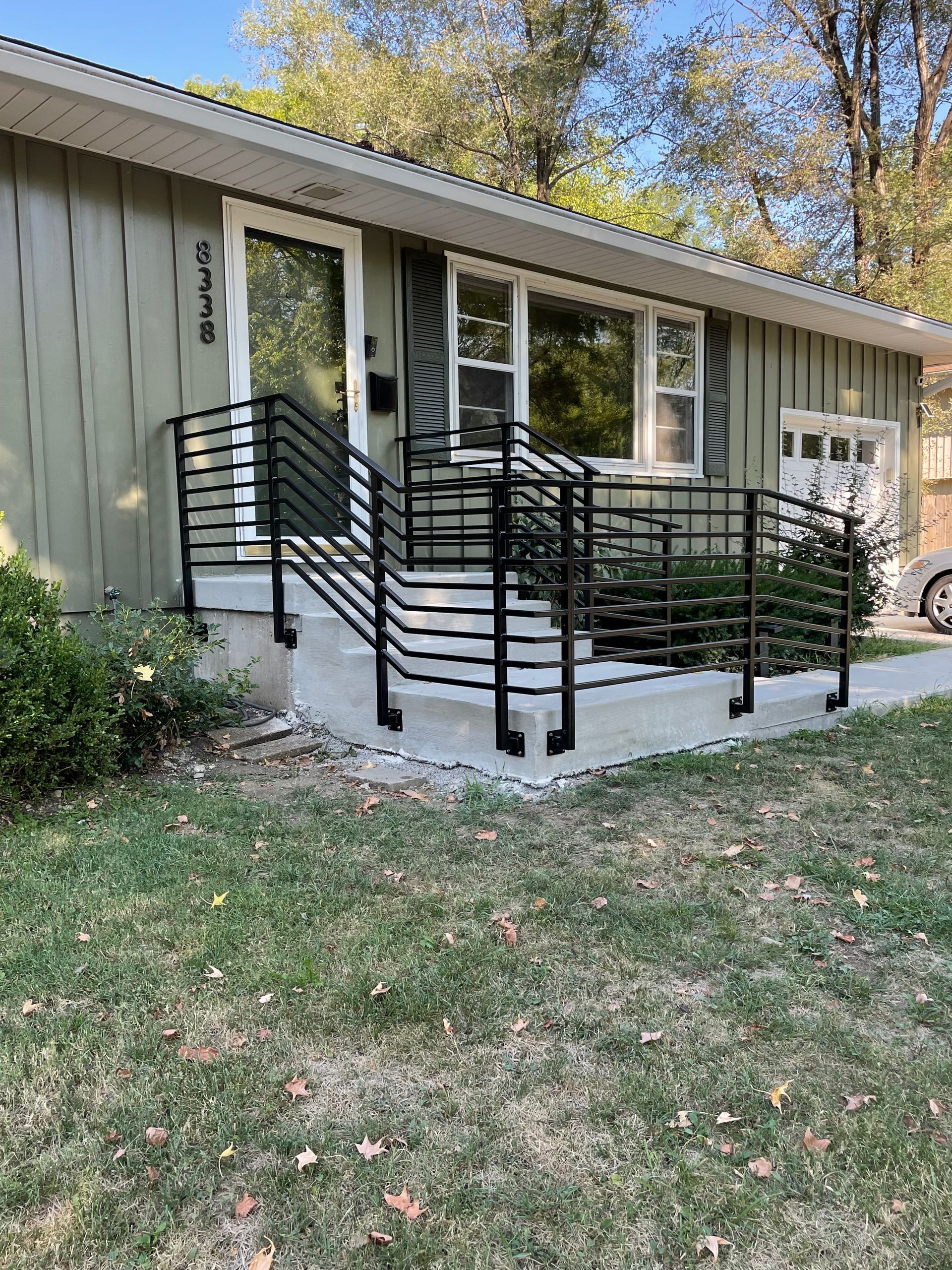 A house with a ramp and a railing on the front porch.
