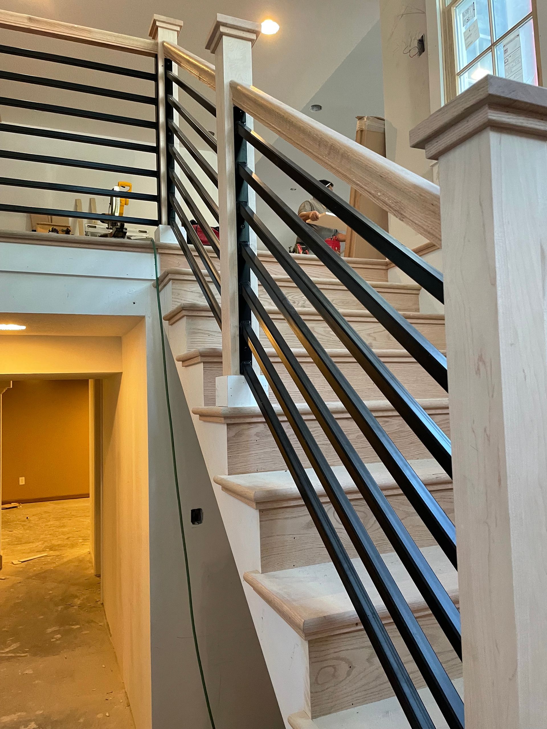 A staircase with a black railing in a house