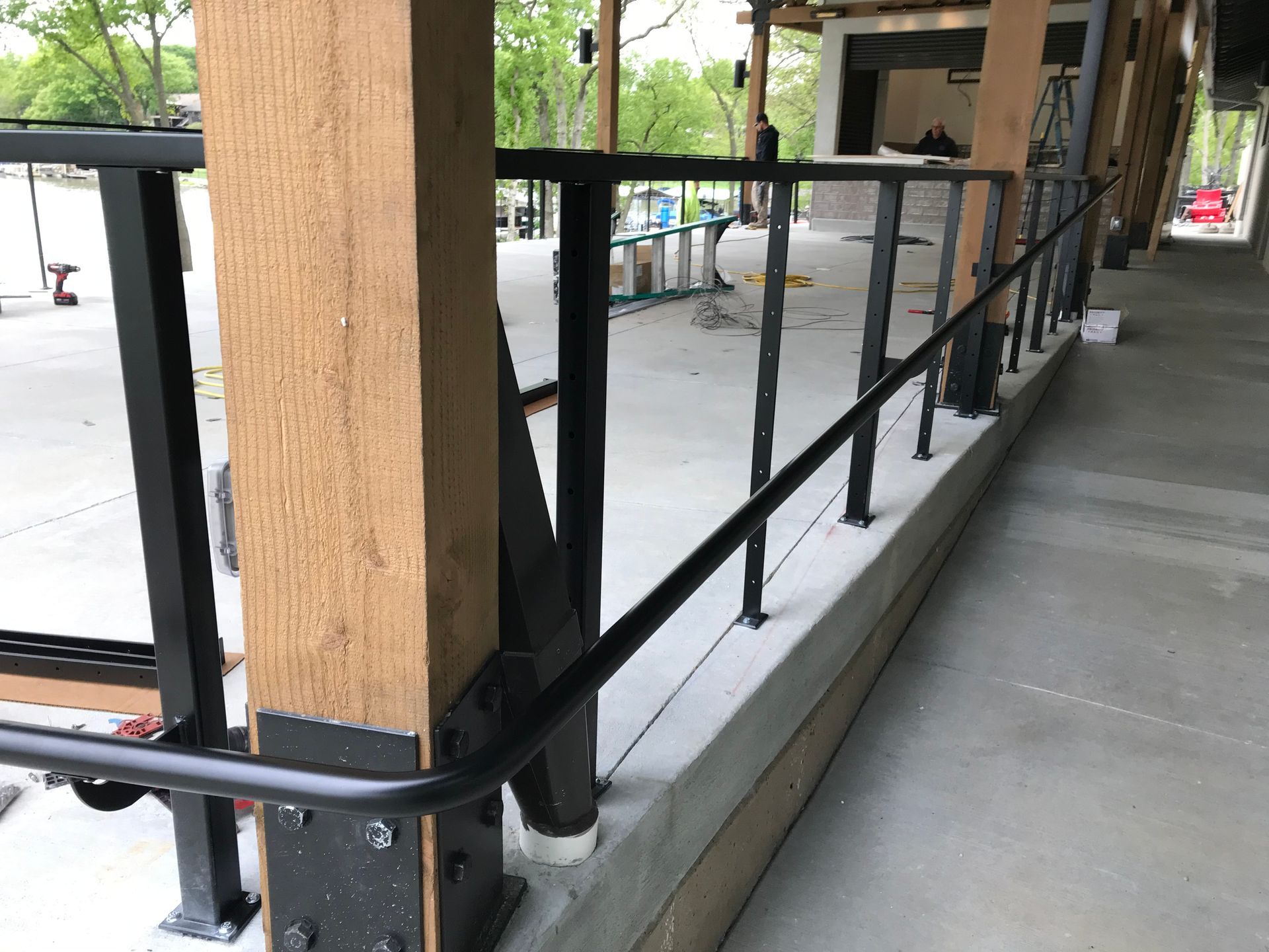 A wooden post with a metal railing attached to it.