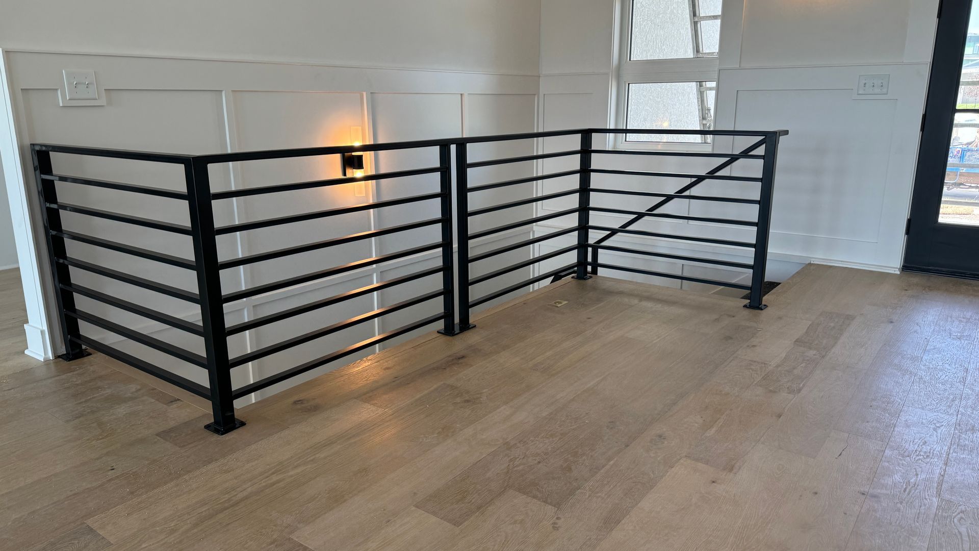 There is a railing in the middle of the room.