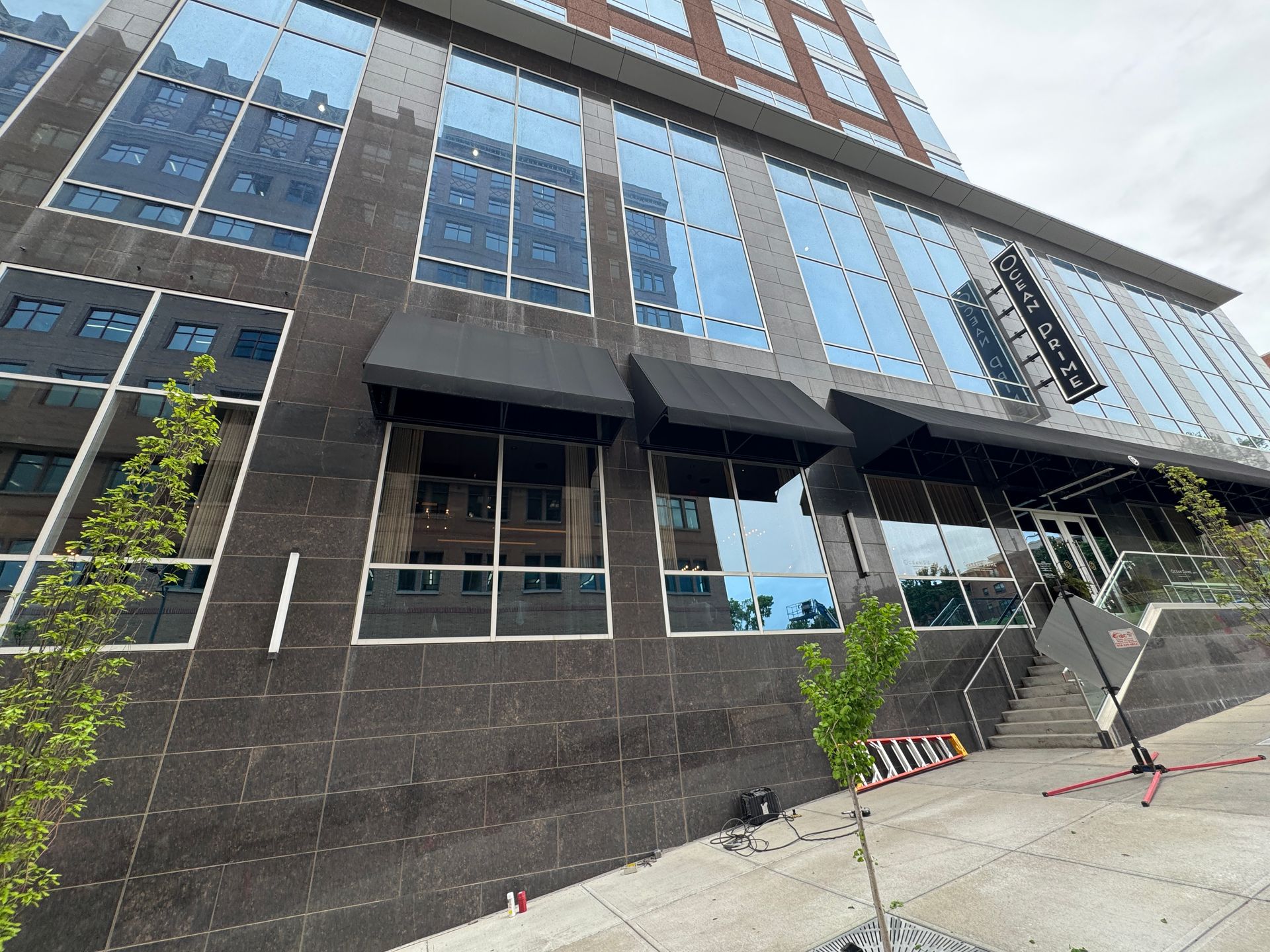 A large building with a black awning on the side of it